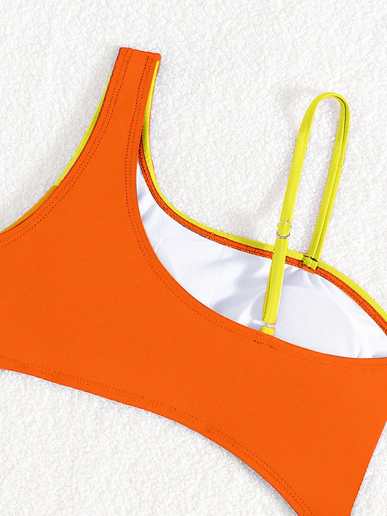 Black one-piece swimsuit for tween girls with cut out detail, spaghetti straps, high waist bottom, wireless bra, and fitted vacation swimwear style.
