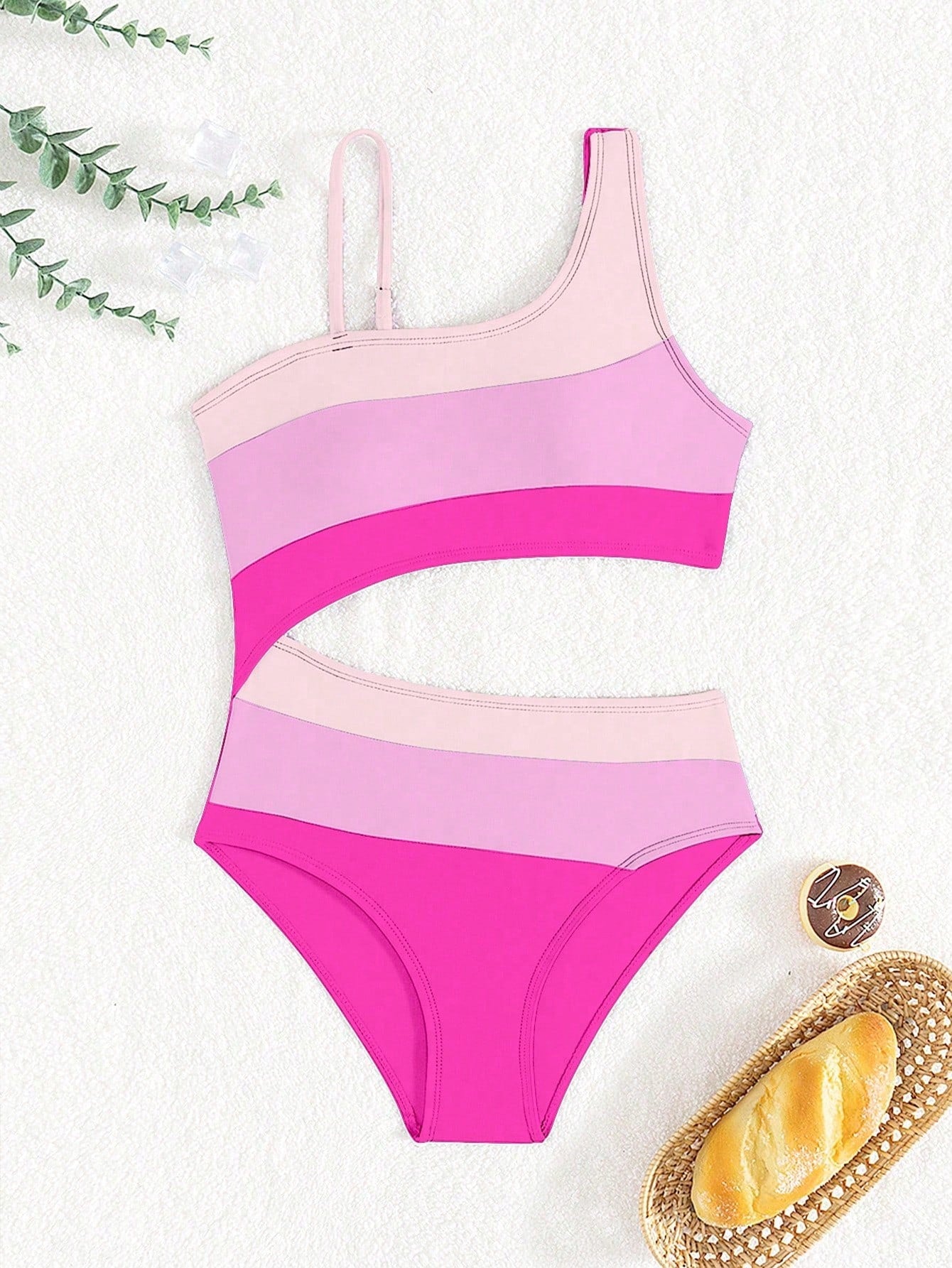 Black one-piece swimsuit for tween girls with cut out detail, spaghetti straps, high waist bottom, wireless bra, and fitted vacation swimwear style.