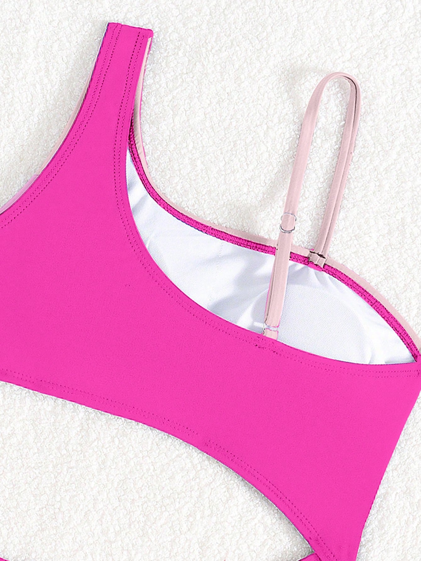 Black one-piece swimsuit for tween girls with cut out detail, spaghetti straps, high waist bottom, wireless bra, and fitted vacation swimwear style.