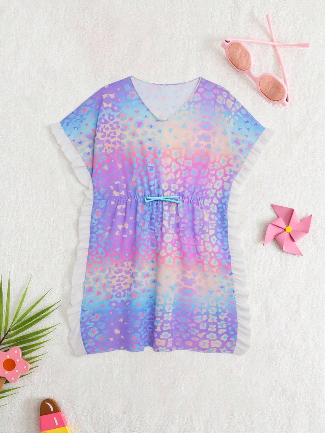 Blue tween girls swimsuit cover up with geometric starfish print, ruffle trim, round neck, short sleeves, and semi-sheer knit fabric for beach or pool wear.