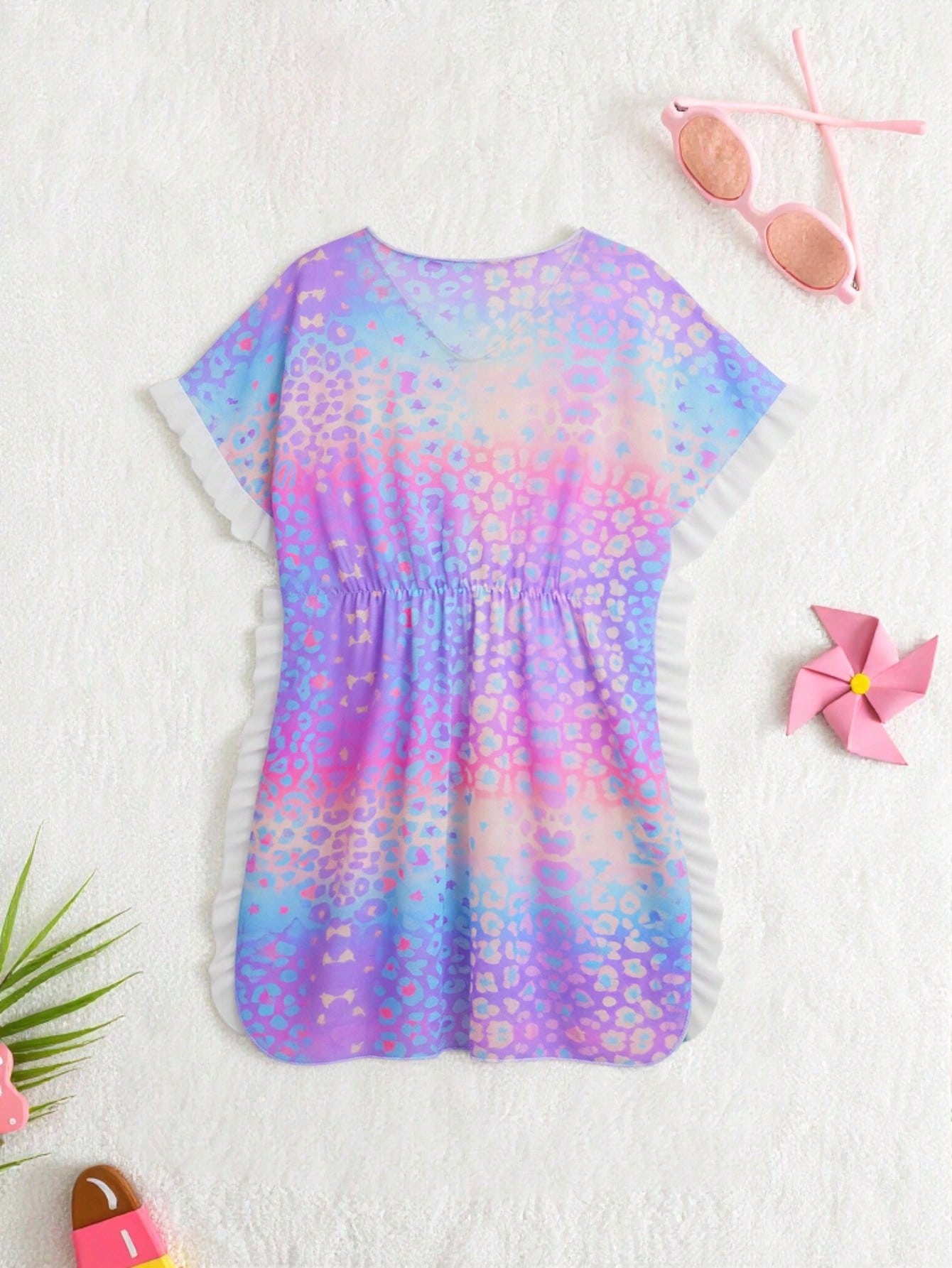 Blue tween girls swimsuit cover up with geometric starfish print, ruffle trim, round neck, short sleeves, and semi-sheer knit fabric for beach or pool wear.