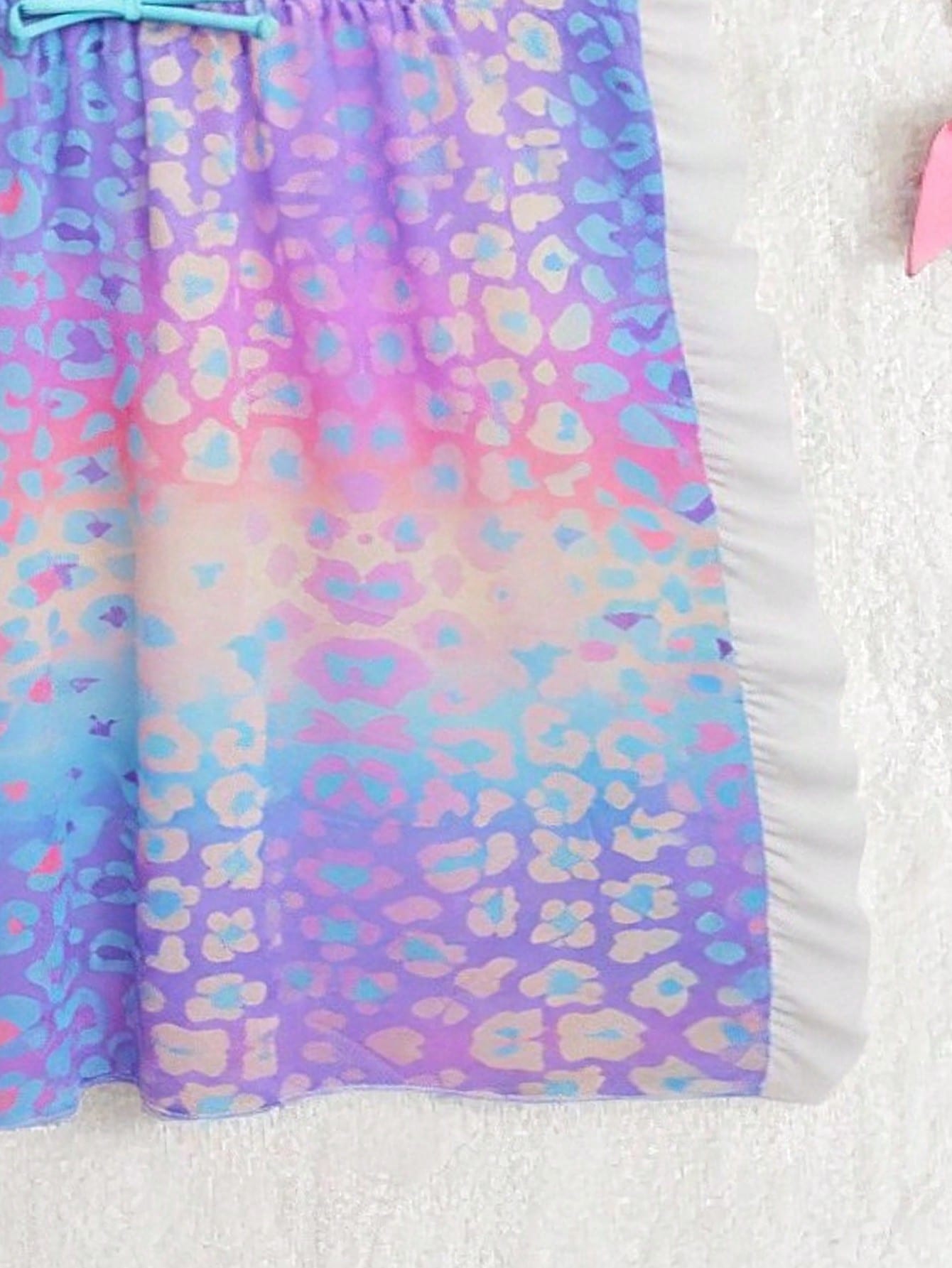 Blue tween girls swimsuit cover up with geometric starfish print, ruffle trim, round neck, short sleeves, and semi-sheer knit fabric for beach or pool wear.