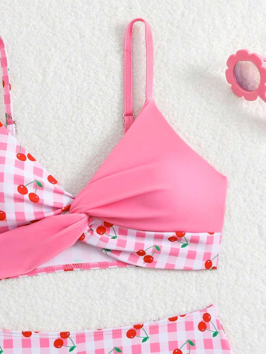 Tween girls multicolor striped 2-piece bikini set with spaghetti strap top, twist detail, and short high-waist or mid-waist swim bottoms for beach and pool wear.