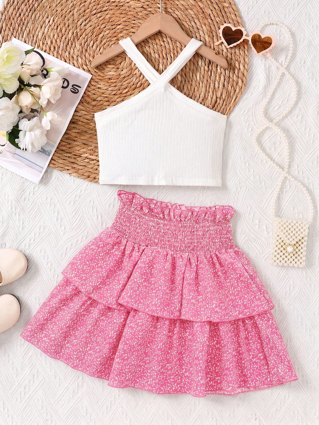 Tween girls blue and white 2-piece set with a striped halter neck vest top and a floral high-waist tiered paperbag skirt.