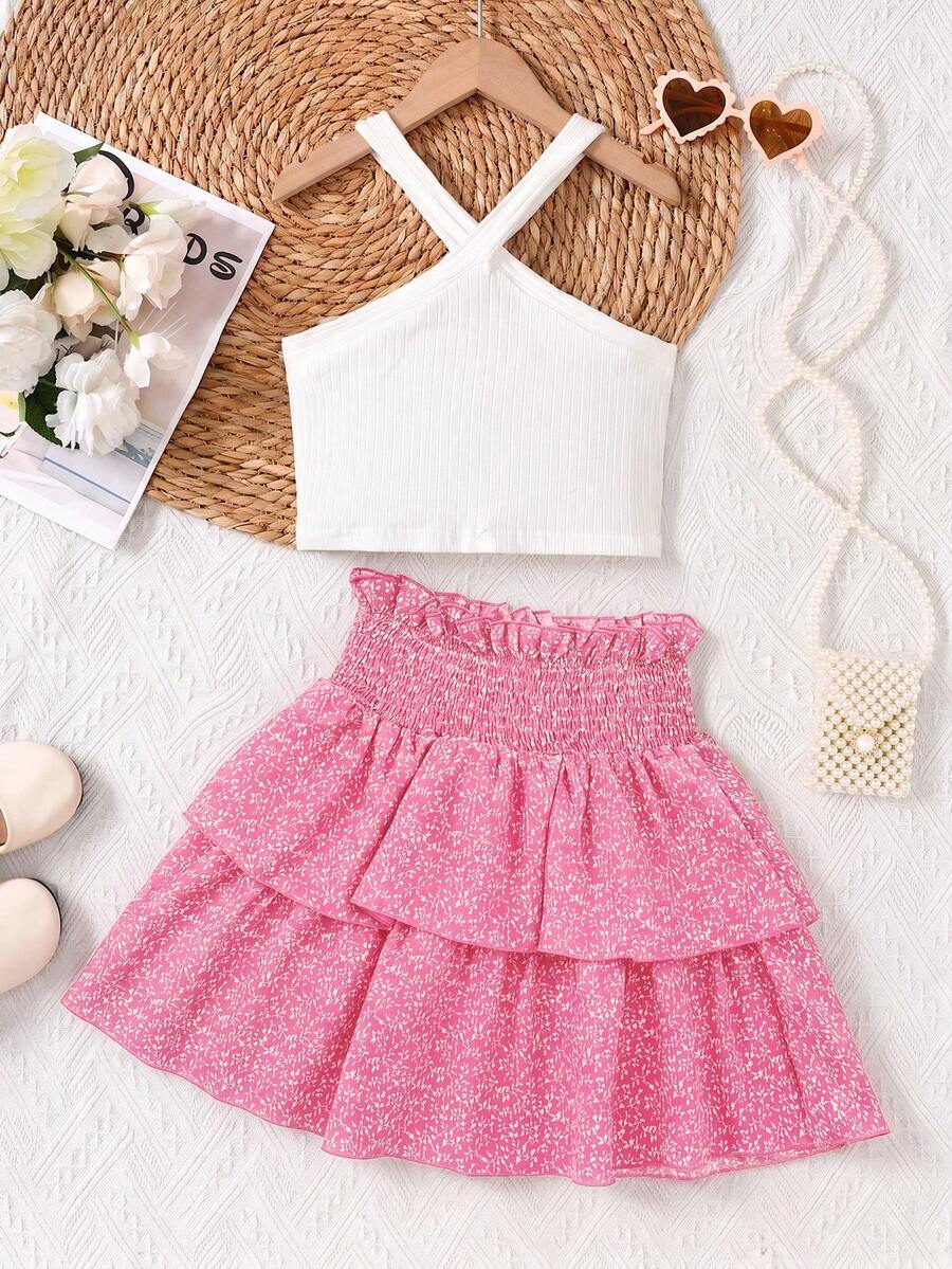 Tween girls blue and white 2-piece set with a striped halter neck vest top and a floral high-waist tiered paperbag skirt.
