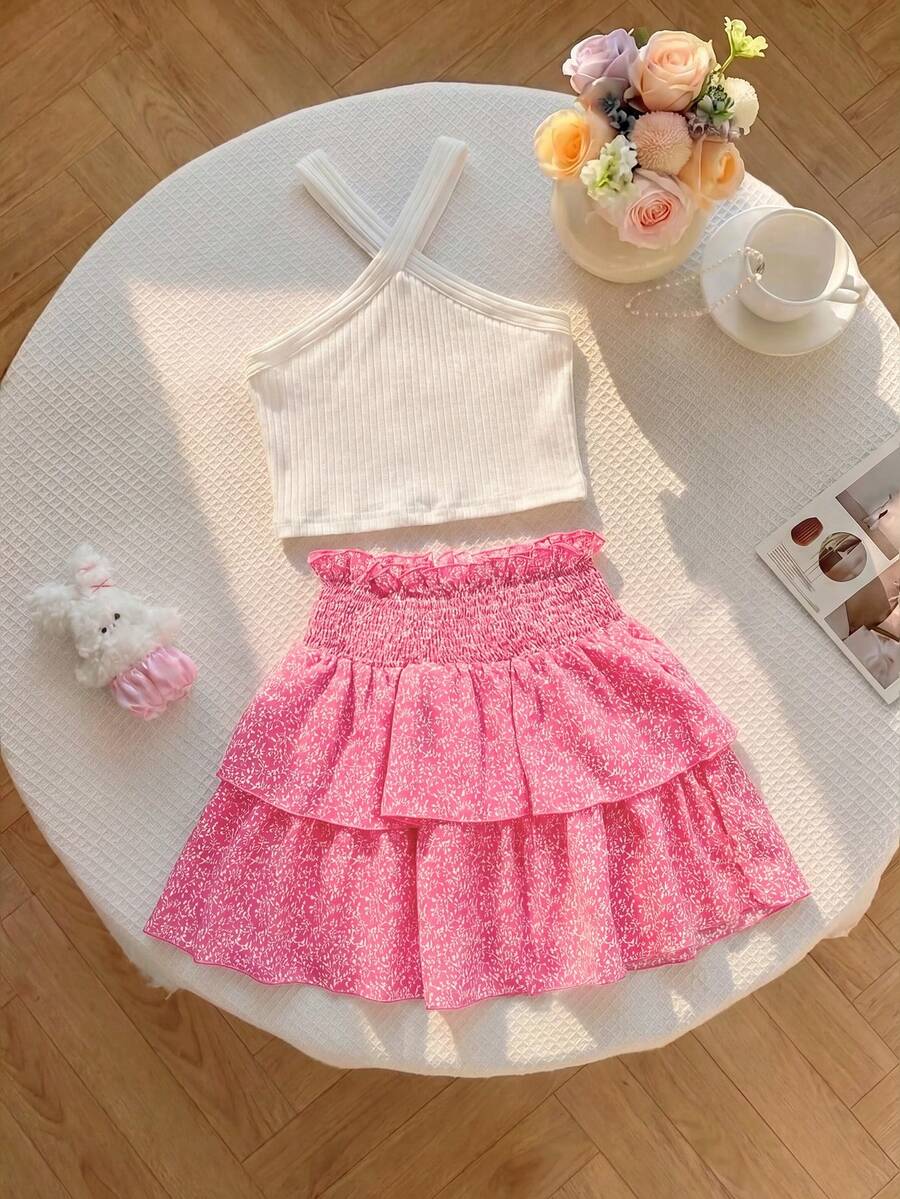Tween girls blue and white 2-piece set with a striped halter neck vest top and a floral high-waist tiered paperbag skirt.