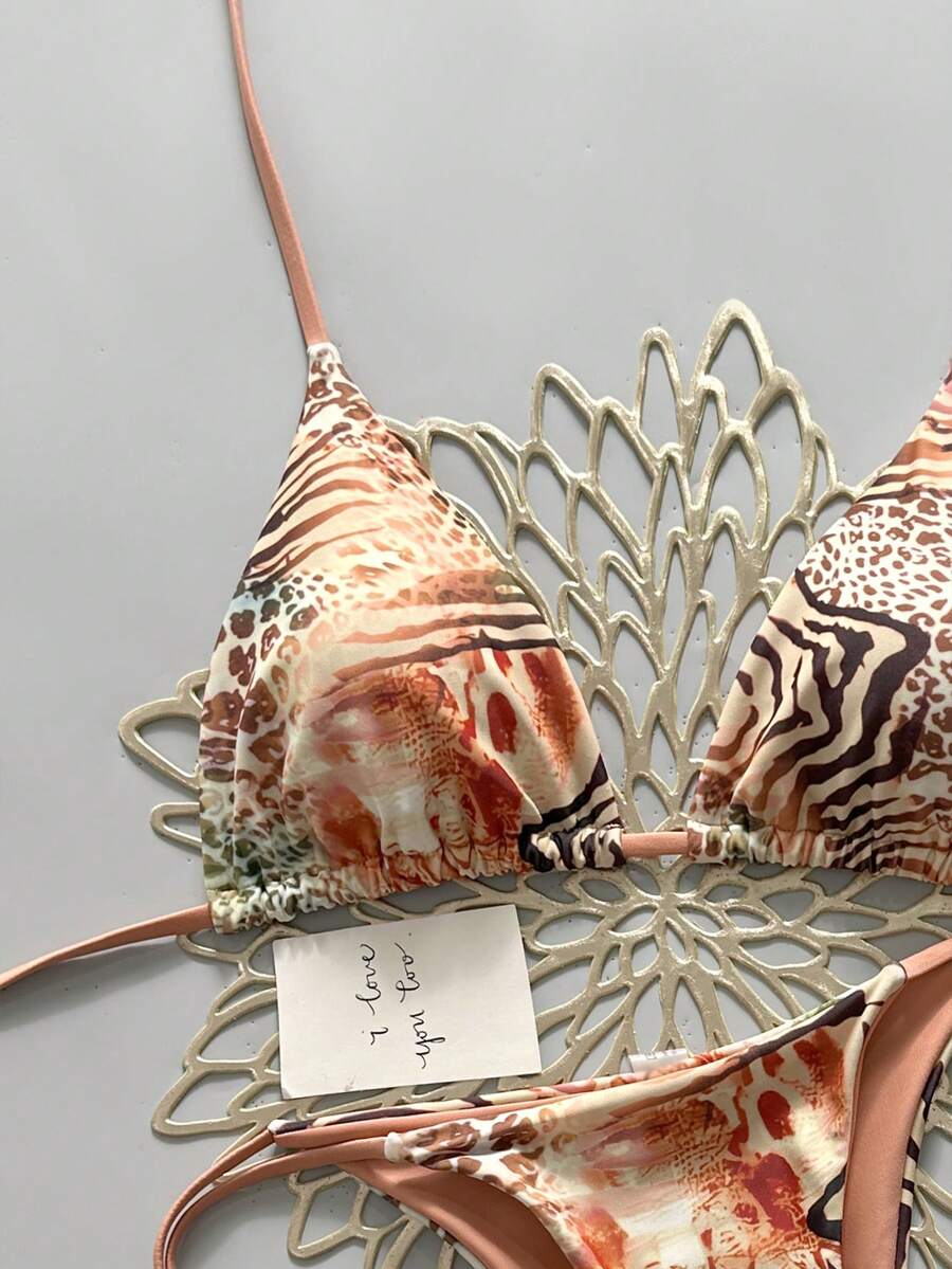 Women's vintage leopard print 2-piece bikini set featuring a high waist tie-side bottom and a halter neck triangle top.