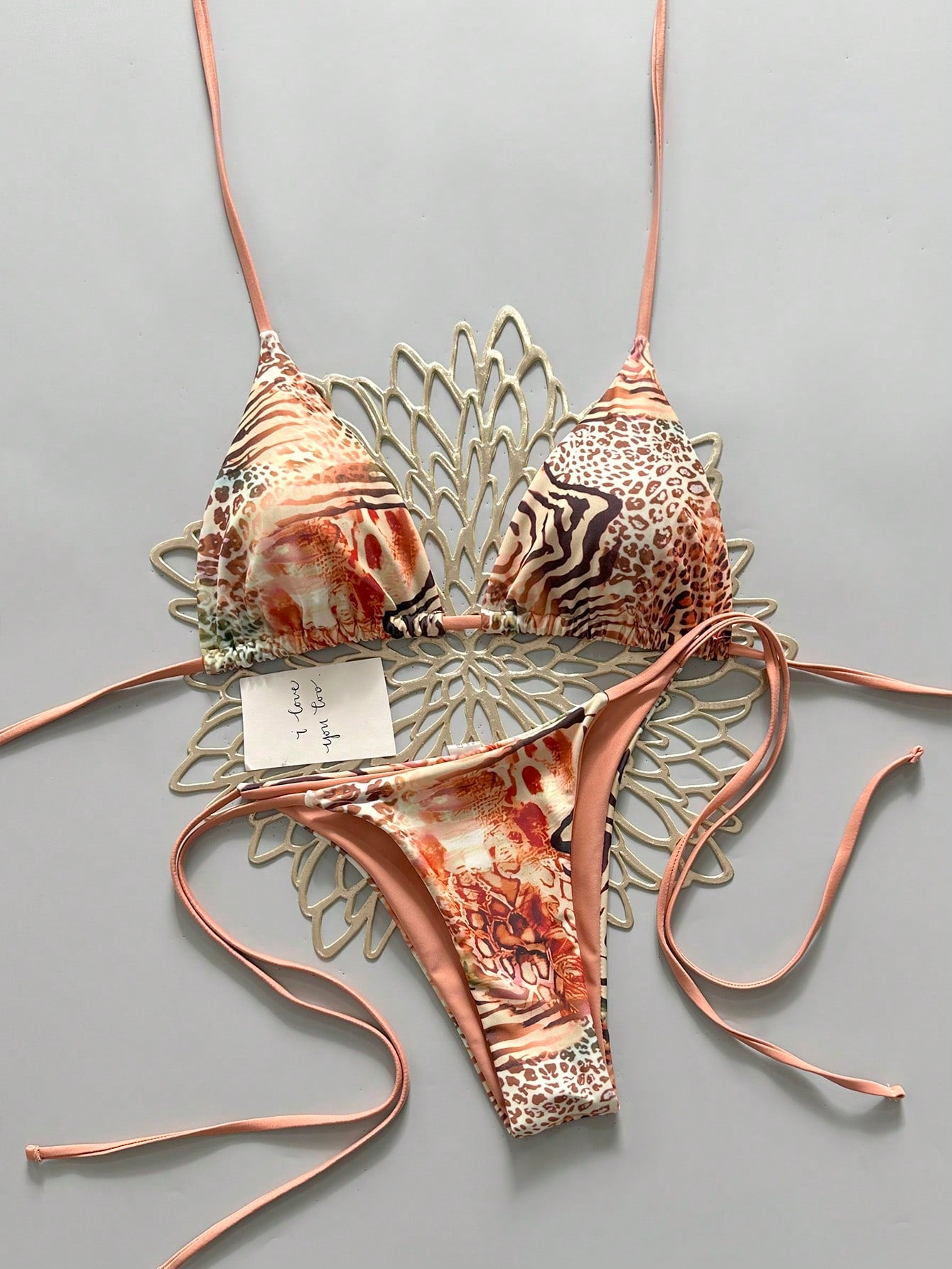 Women's vintage leopard print 2-piece bikini set featuring a high waist tie-side bottom and a halter neck triangle top.