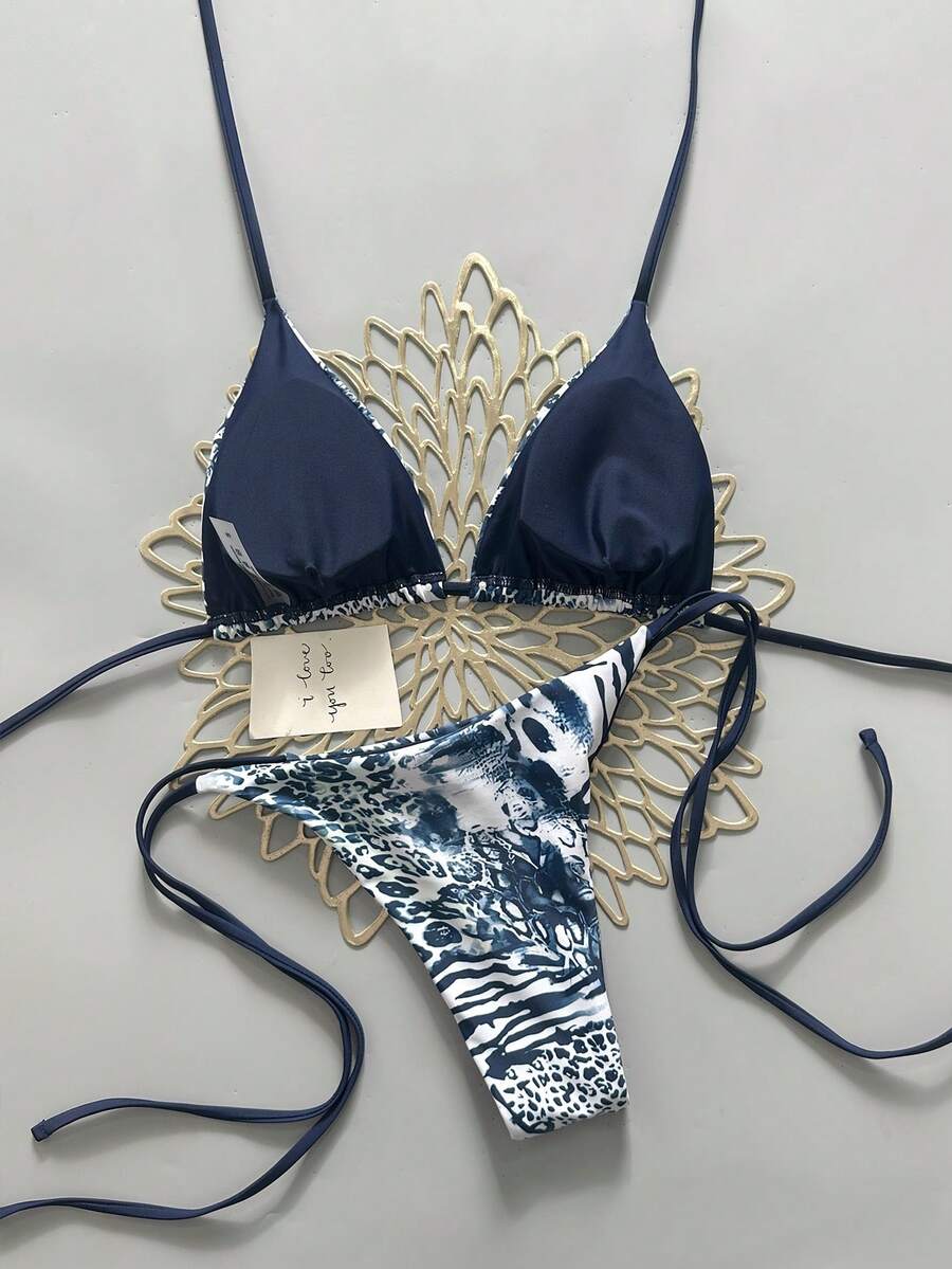 Women's vintage leopard print 2-piece bikini set featuring a high waist tie-side bottom and a halter neck triangle top.