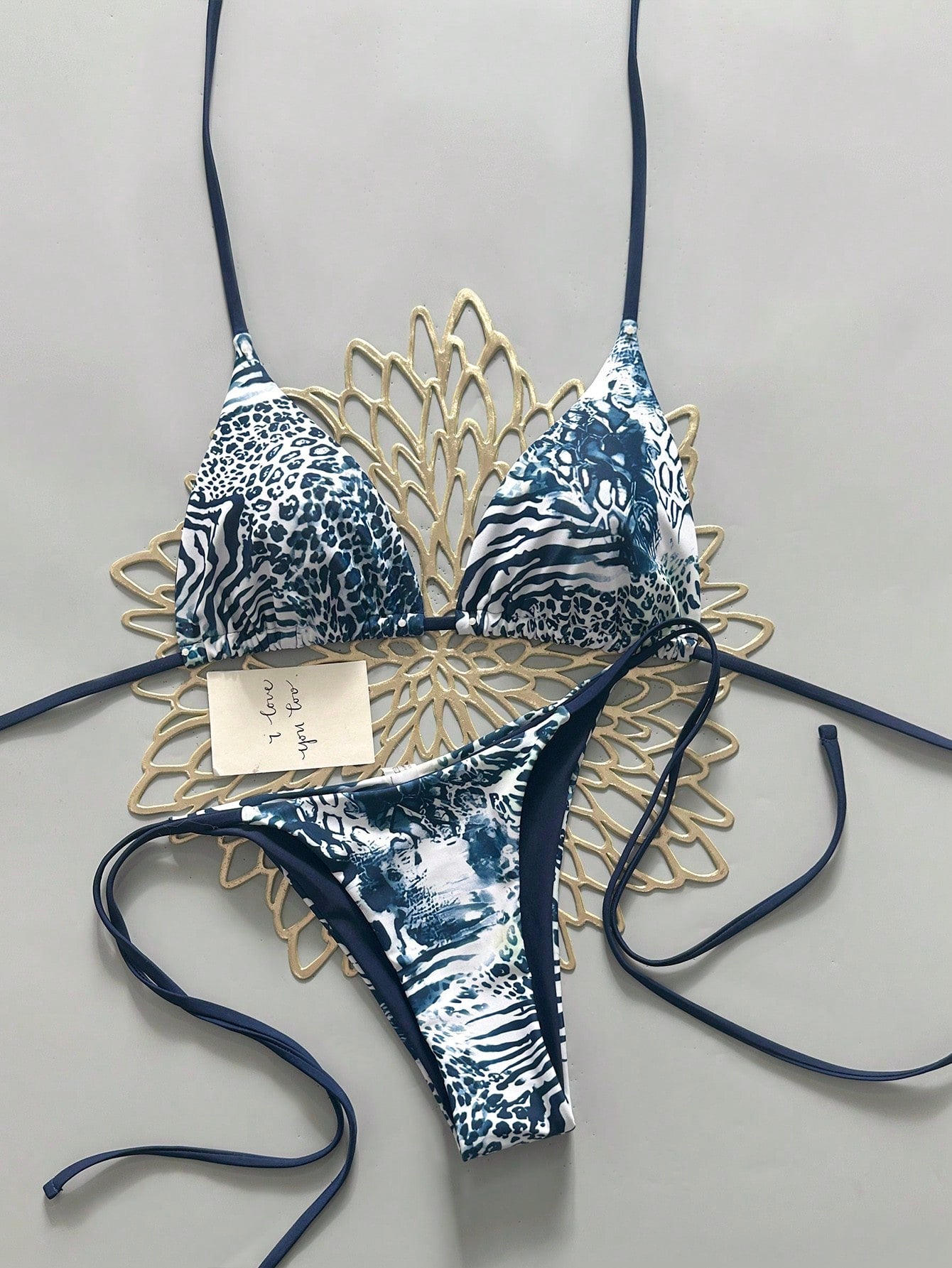 Women's vintage leopard print 2-piece bikini set featuring a high waist tie-side bottom and a halter neck triangle top.