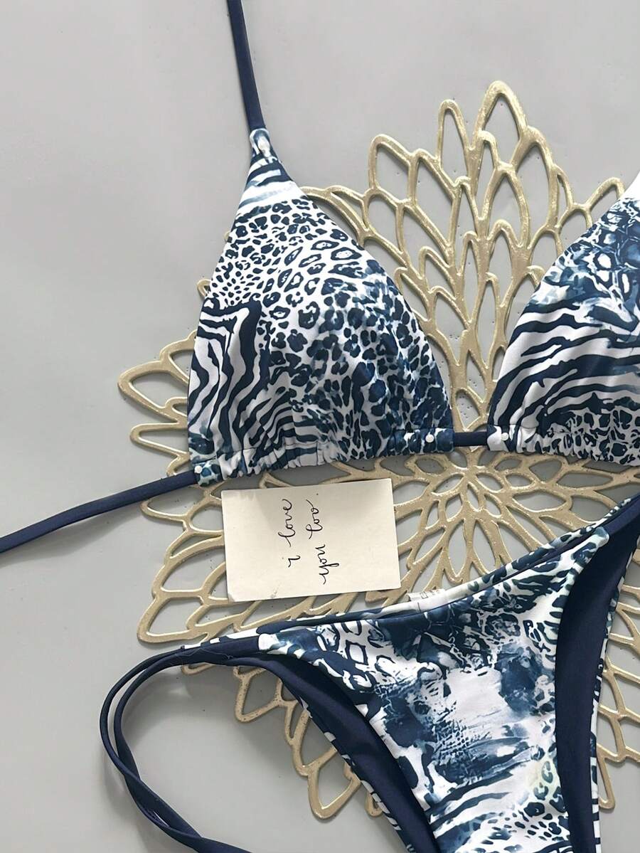 Women's vintage leopard print 2-piece bikini set featuring a high waist tie-side bottom and a halter neck triangle top.