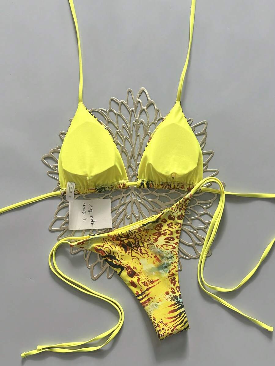 Women's vintage leopard print 2-piece bikini set featuring a high waist tie-side bottom and a halter neck triangle top.