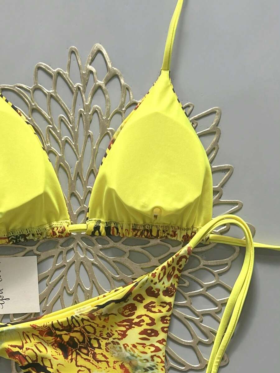 Women's vintage leopard print 2-piece bikini set featuring a high waist tie-side bottom and a halter neck triangle top.