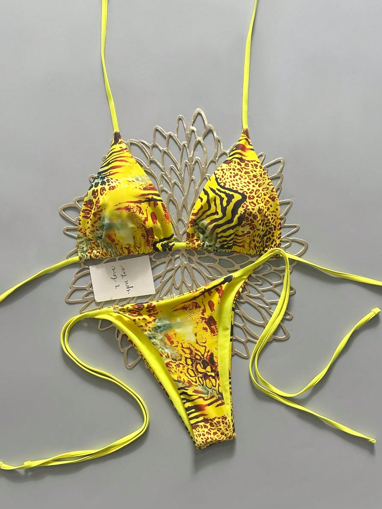 Women's vintage leopard print 2-piece bikini set featuring a high waist tie-side bottom and a halter neck triangle top.