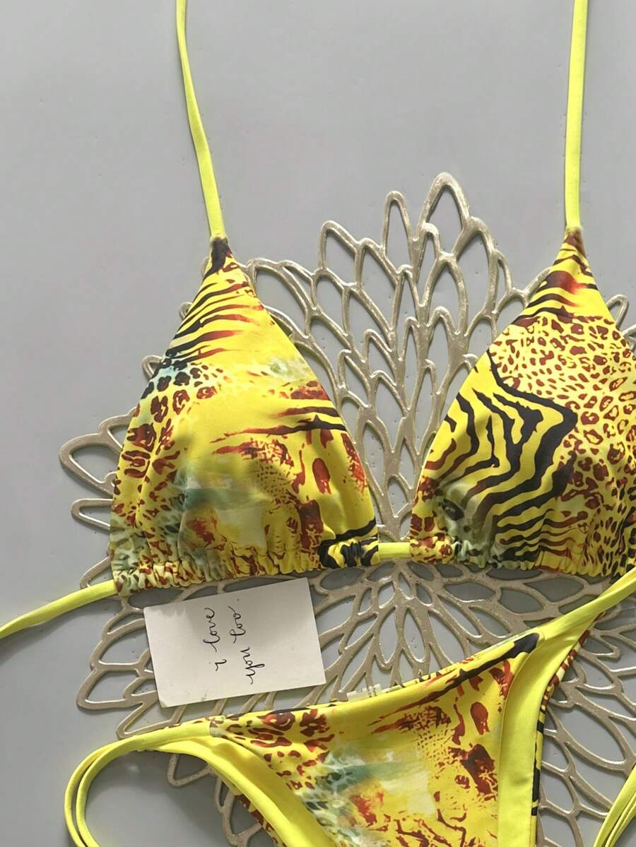 Women's vintage leopard print 2-piece bikini set featuring a high waist tie-side bottom and a halter neck triangle top.