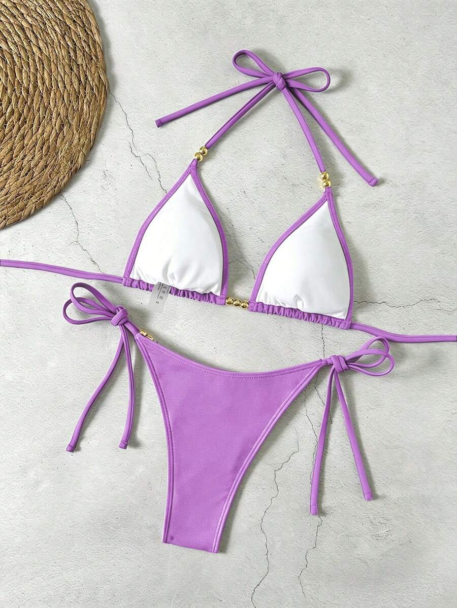Women's black halter bikini set featuring triangle cups with gold bead decor and tie-back closure