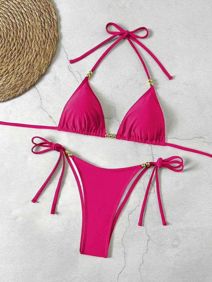 Women's black halter bikini set featuring triangle cups with gold bead decor and tie-back closure