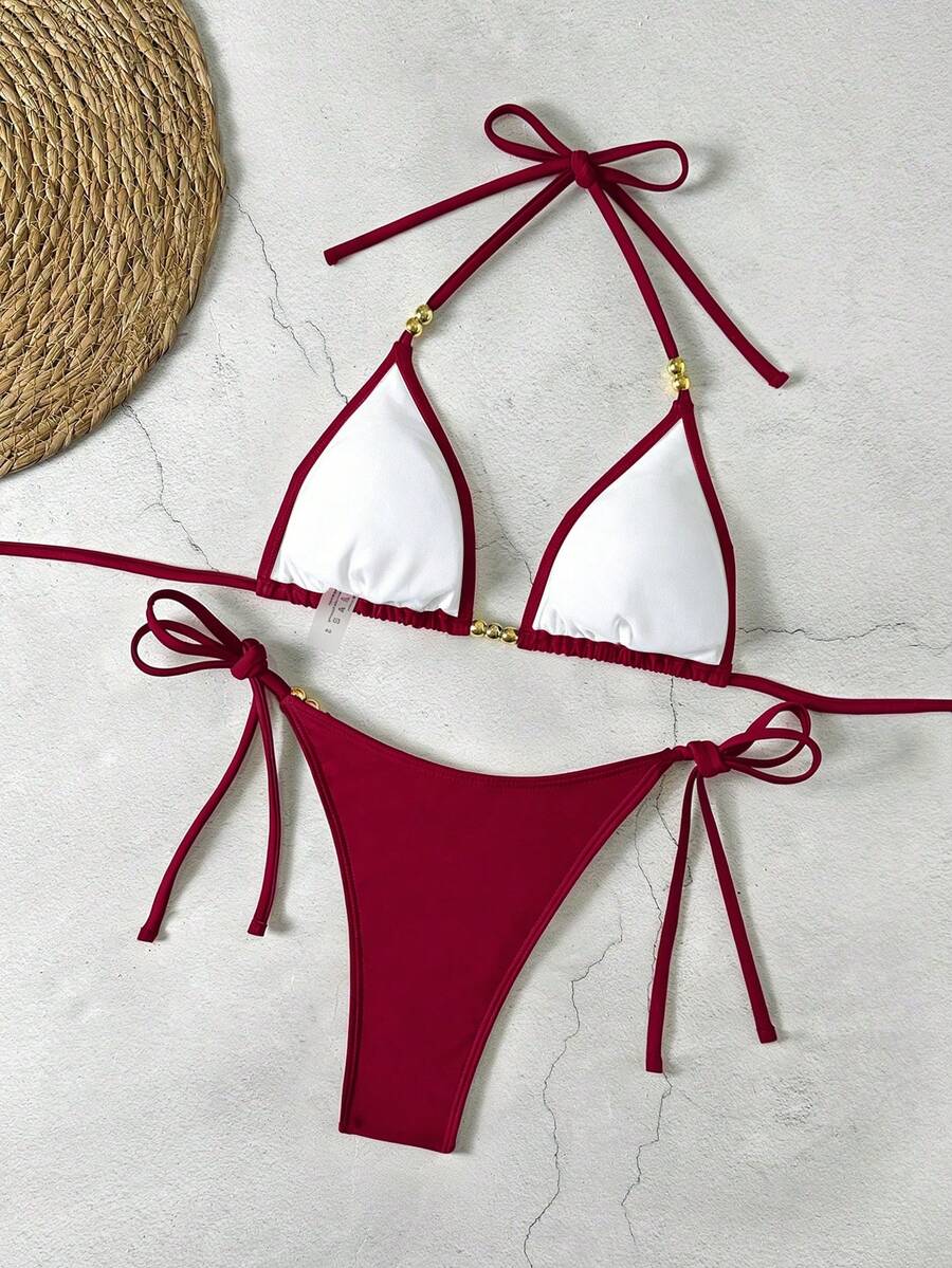 Women's black halter bikini set featuring triangle cups with gold bead decor and tie-back closure