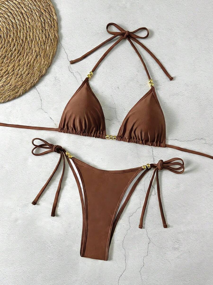 Women's black halter bikini set featuring triangle cups with gold bead decor and tie-back closure