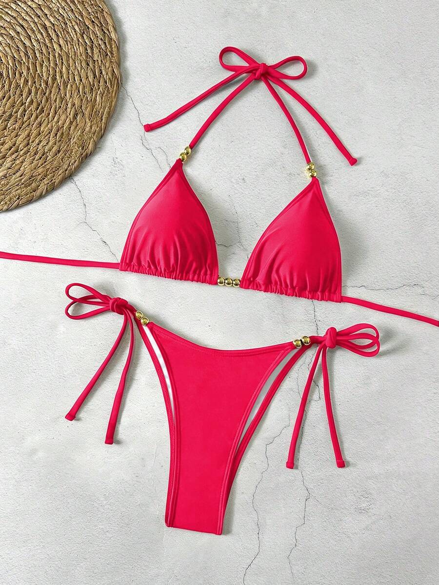 Women's black halter bikini set featuring triangle cups with gold bead decor and tie-back closure