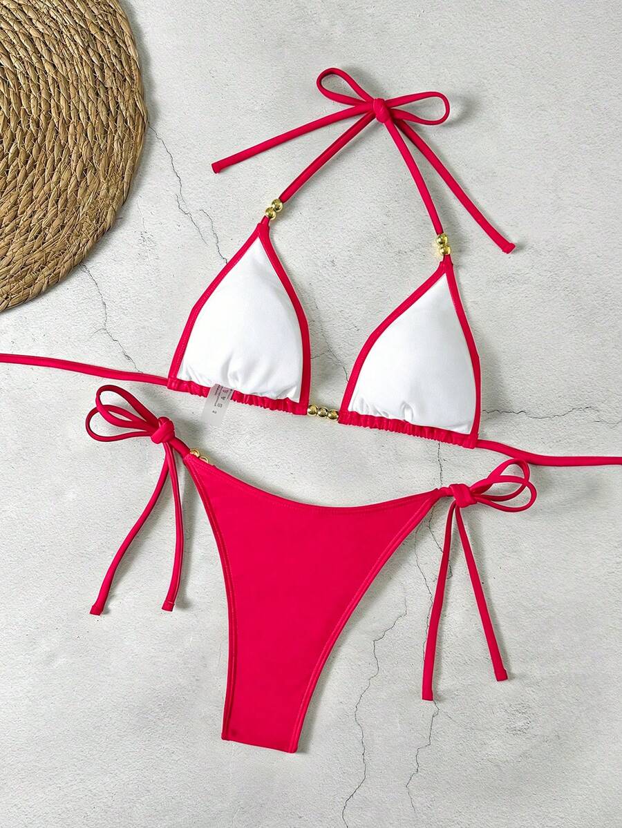 Women's black halter bikini set featuring triangle cups with gold bead decor and tie-back closure