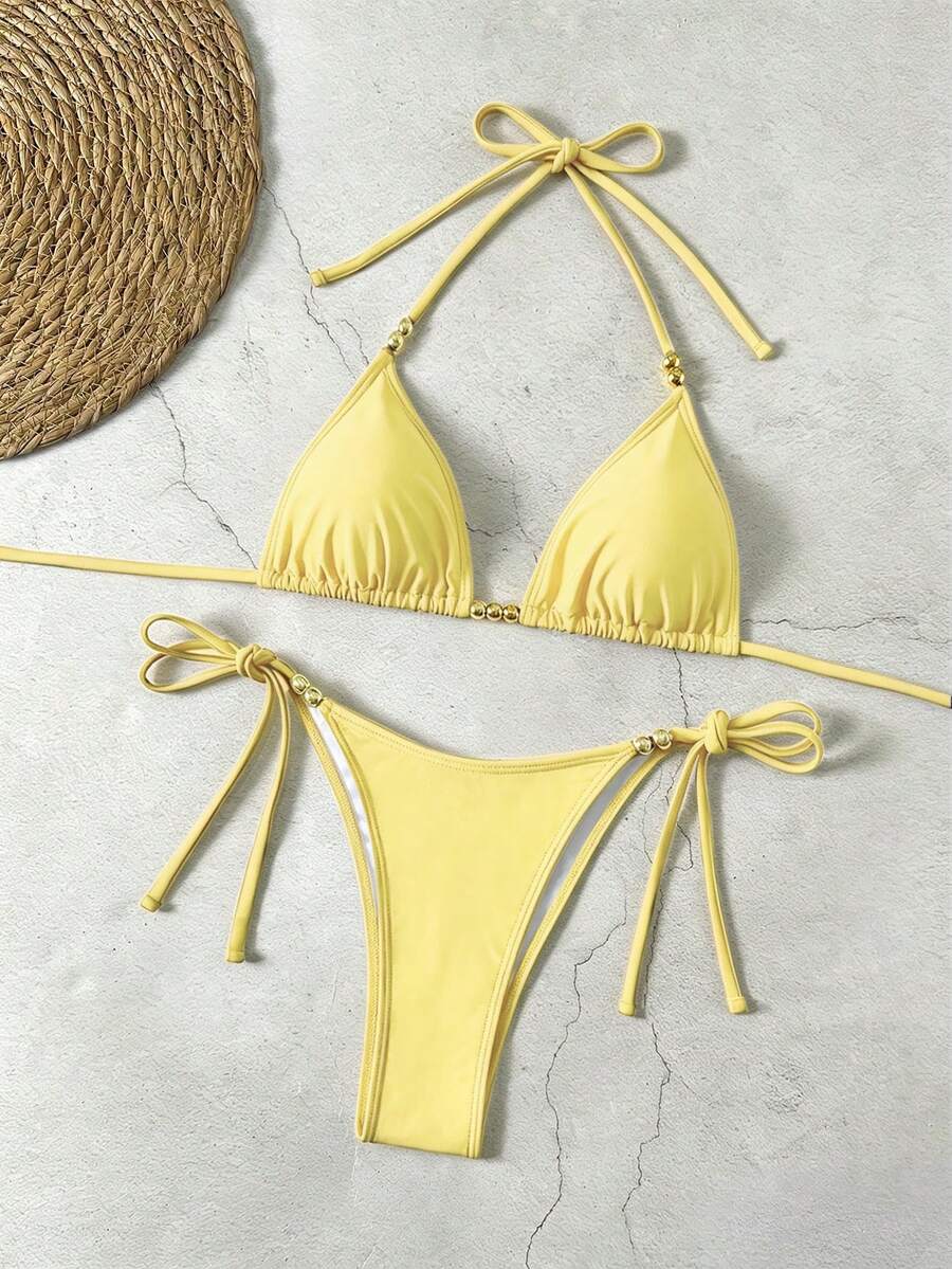 Women's black halter bikini set featuring triangle cups with gold bead decor and tie-back closure