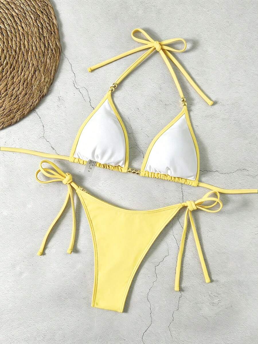 Women's black halter bikini set featuring triangle cups with gold bead decor and tie-back closure