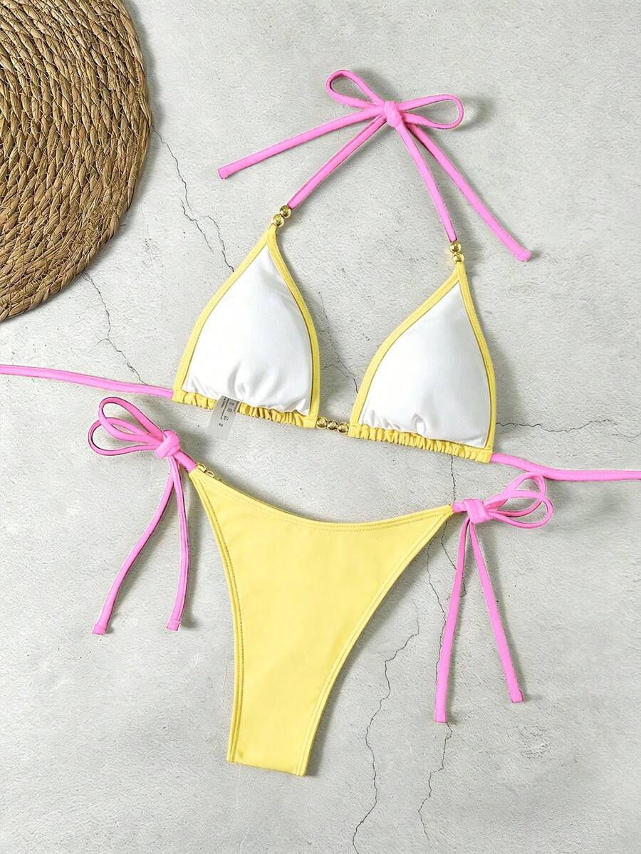 Women's black halter bikini set featuring triangle cups with gold bead decor and tie-back closure