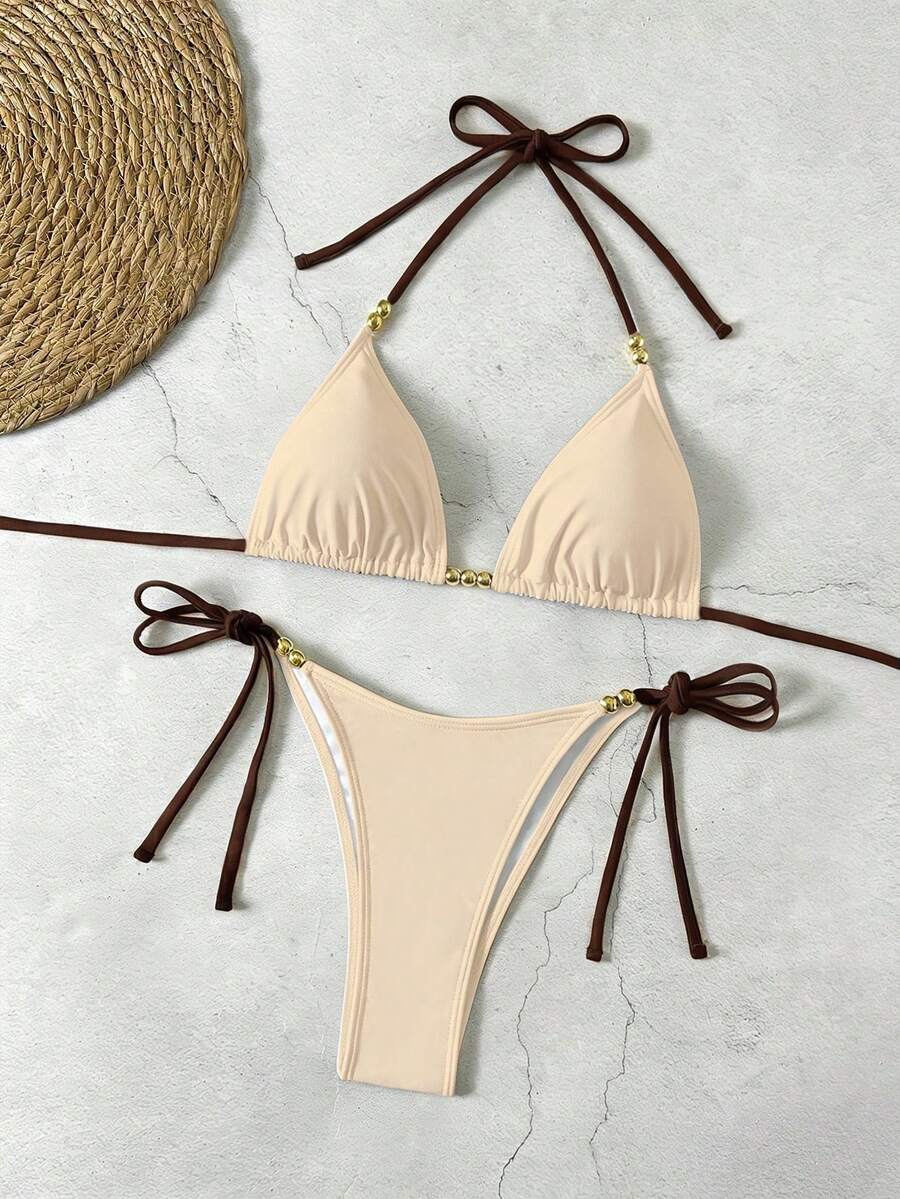Women's black halter bikini set featuring triangle cups with gold bead decor and tie-back closure