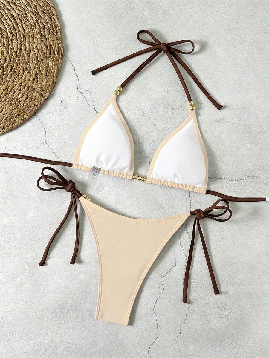 Women's black halter bikini set featuring triangle cups with gold bead decor and tie-back closure