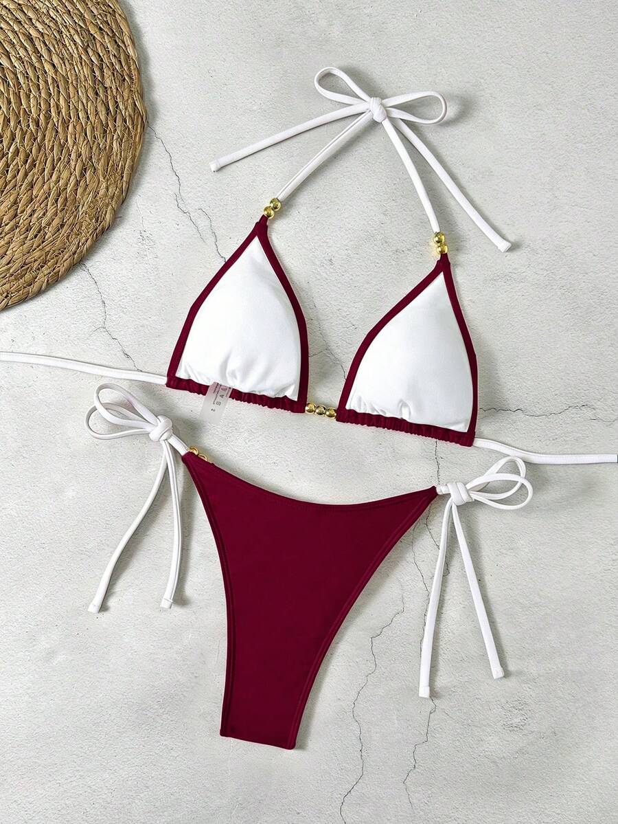 Women's black halter bikini set featuring triangle cups with gold bead decor and tie-back closure
