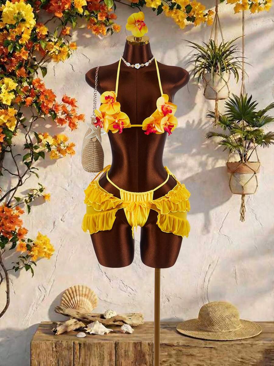 Women's 3-piece blue bikini swimwear set featuring a crop top with 3D rose accents, tie back detail, spaghetti straps, and tie-side bottoms.
