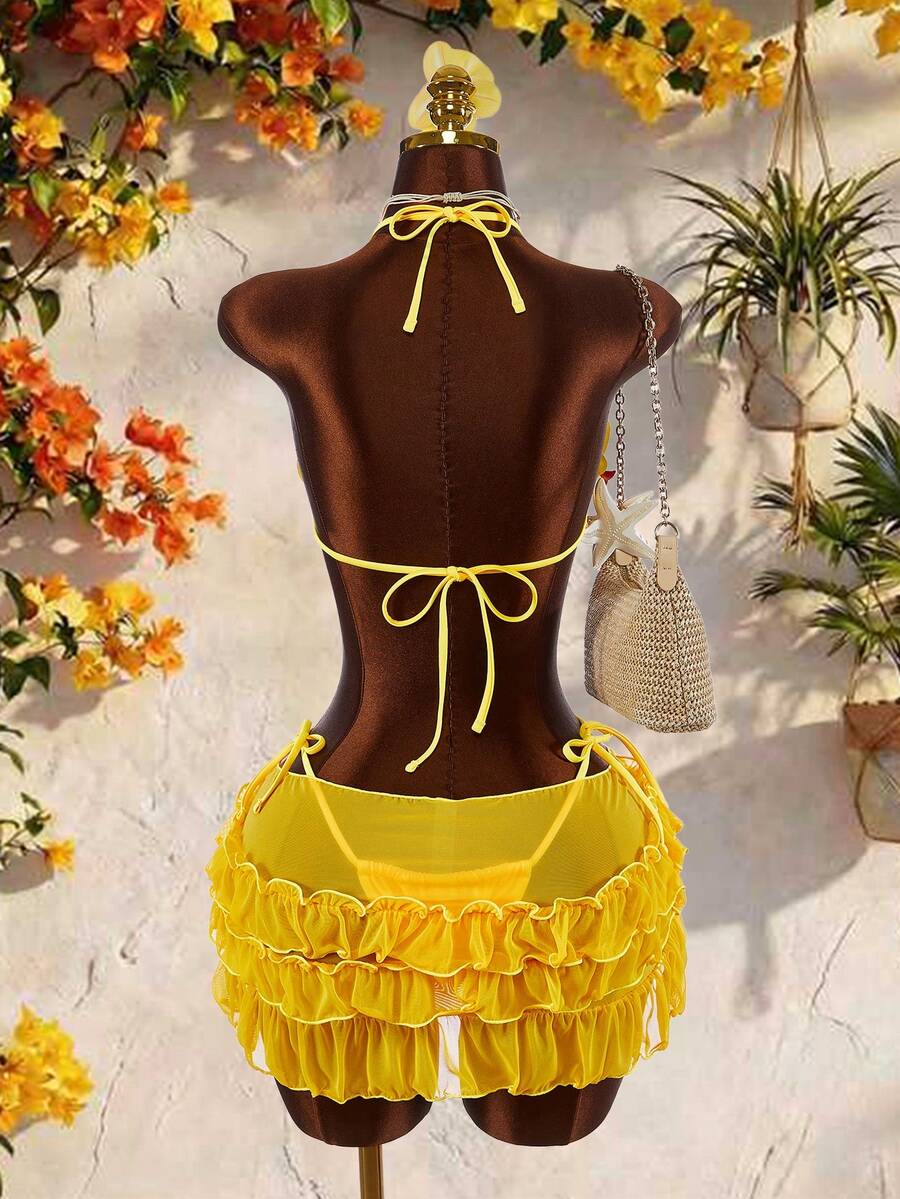 Women's 3-piece blue bikini swimwear set featuring a crop top with 3D rose accents, tie back detail, spaghetti straps, and tie-side bottoms.