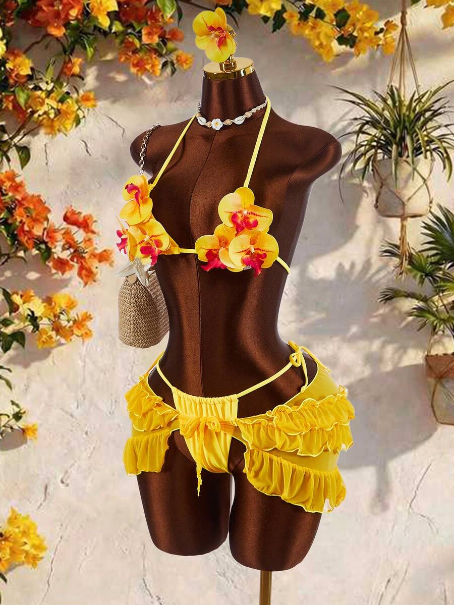 Women's 3-piece blue bikini swimwear set featuring a crop top with 3D rose accents, tie back detail, spaghetti straps, and tie-side bottoms.