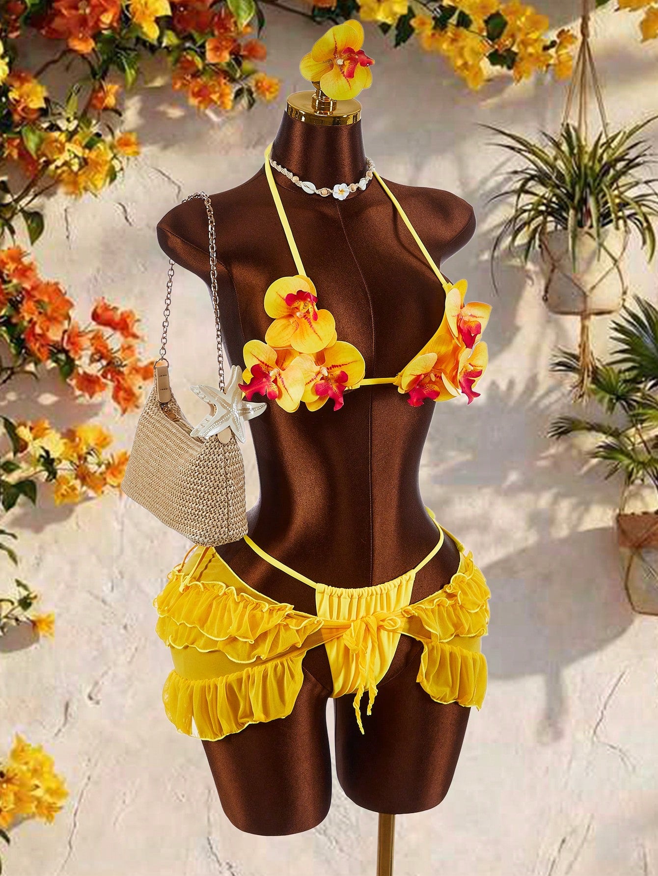 Women's 3-piece blue bikini swimwear set featuring a crop top with 3D rose accents, tie back detail, spaghetti straps, and tie-side bottoms.