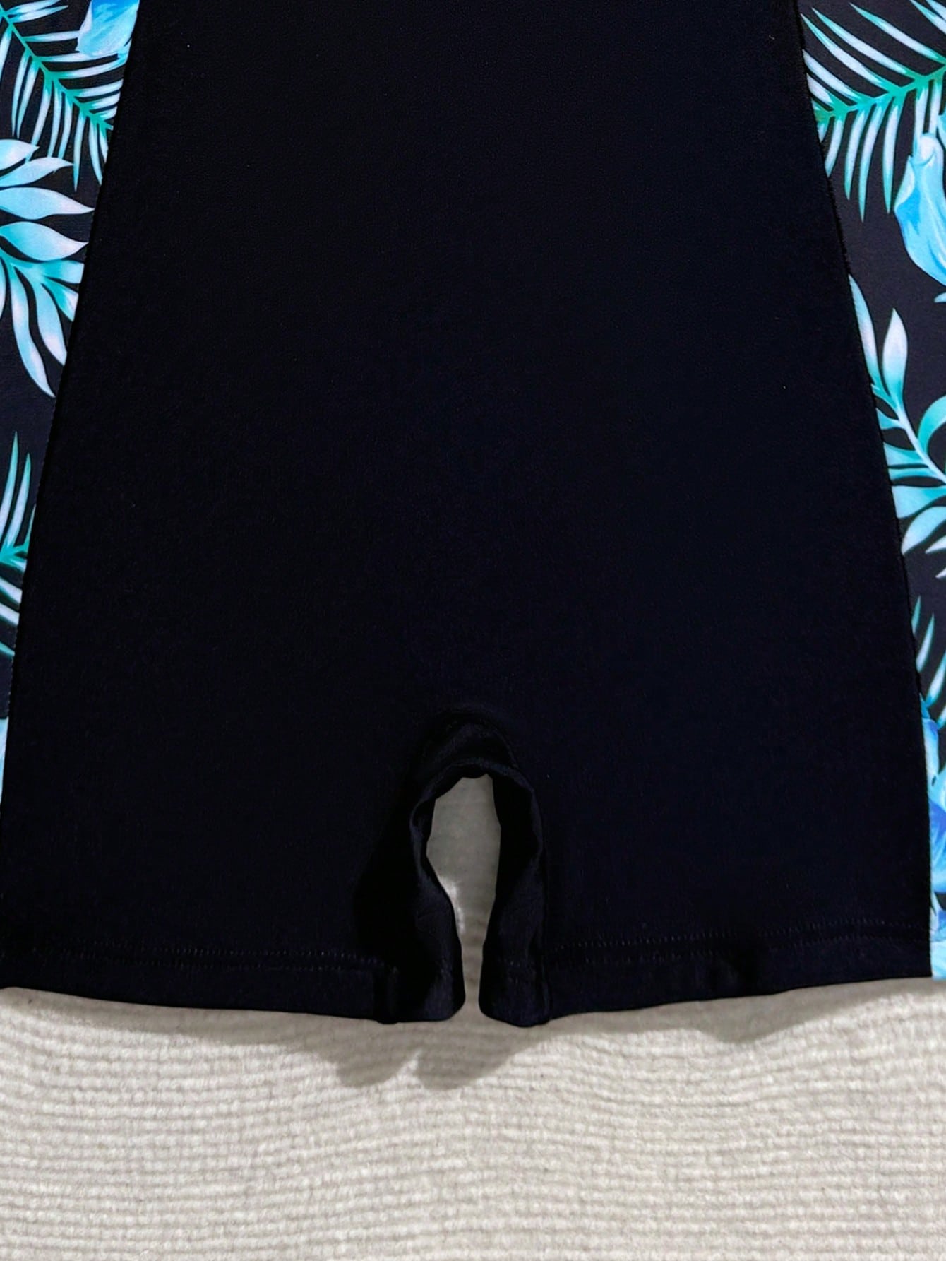 Tween girls one-piece swimsuit with scoop neck, contrast piping, short length, and shorts bottom for summer beach and vacation wear