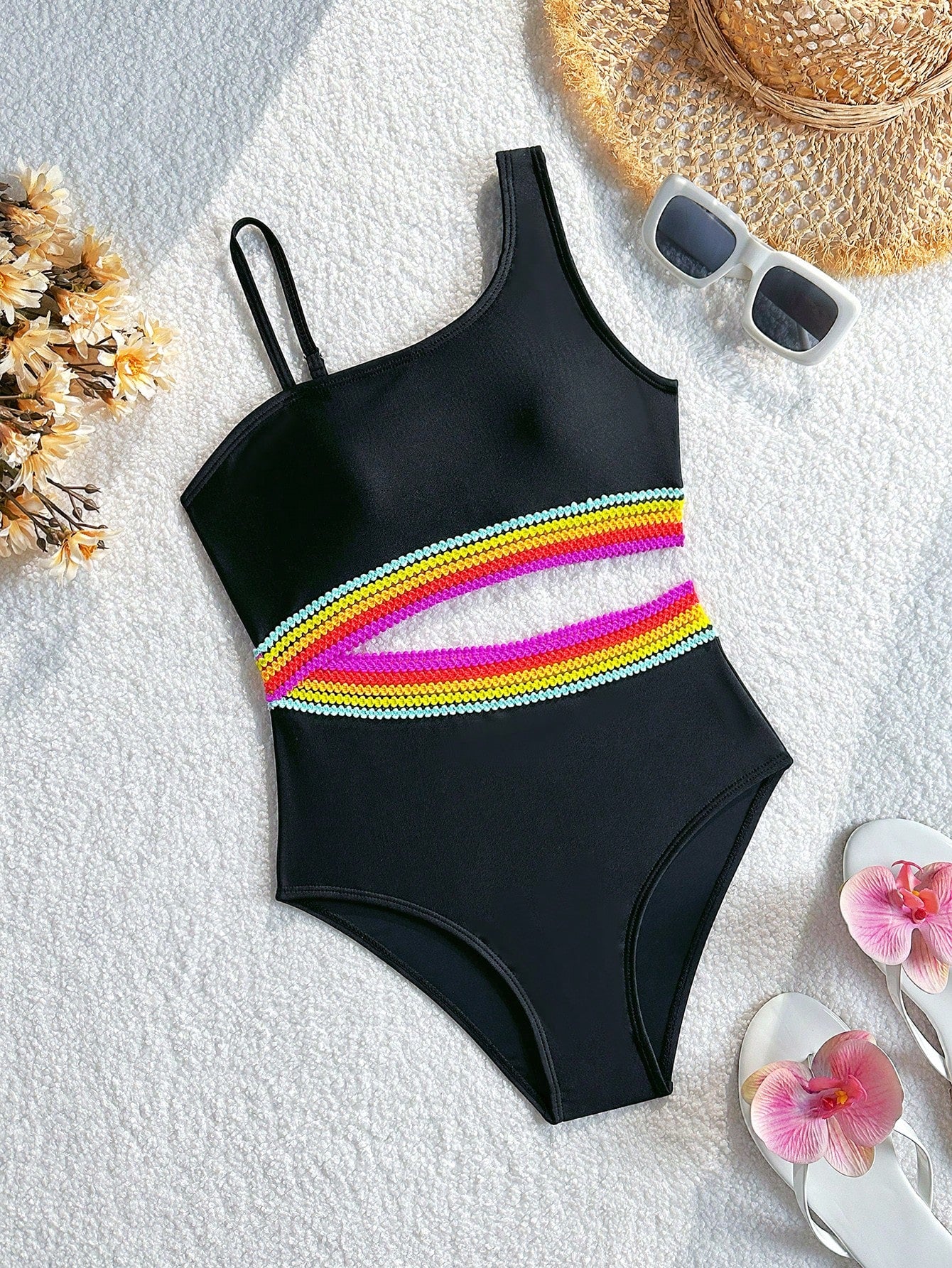 Black one-piece swimsuit for tween girls with cut out detail, spaghetti straps, high waist bottom, wireless bra, and fitted vacation swimwear style.