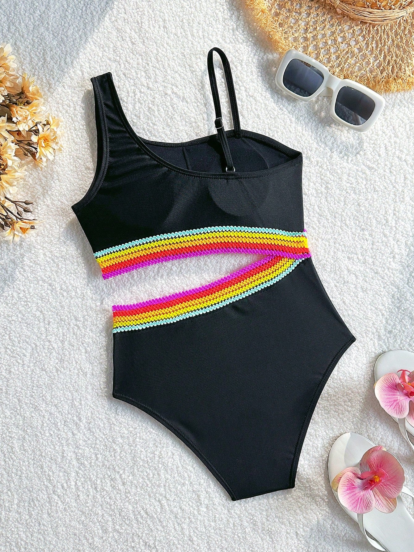 Black one-piece swimsuit for tween girls with cut out detail, spaghetti straps, high waist bottom, wireless bra, and fitted vacation swimwear style.