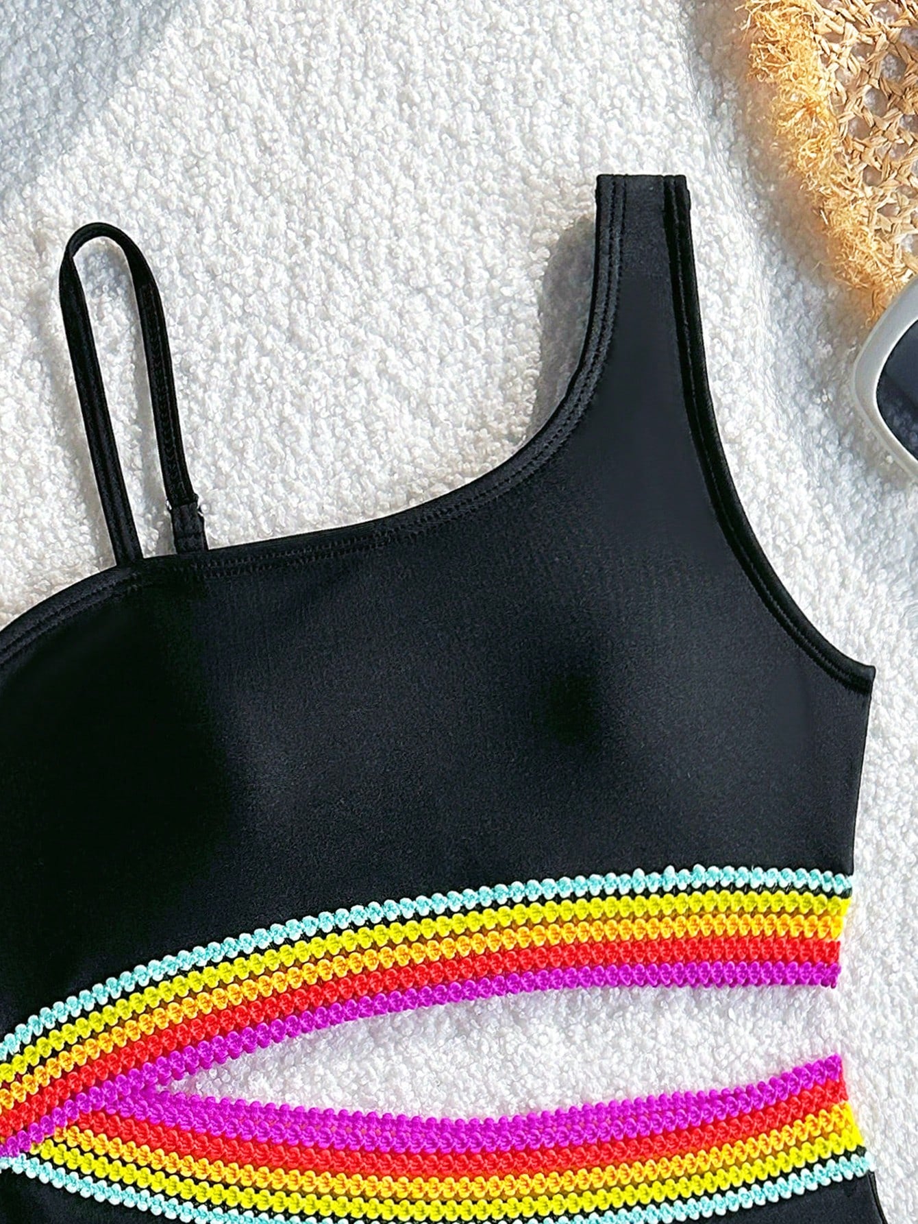 Black one-piece swimsuit for tween girls with cut out detail, spaghetti straps, high waist bottom, wireless bra, and fitted vacation swimwear style.