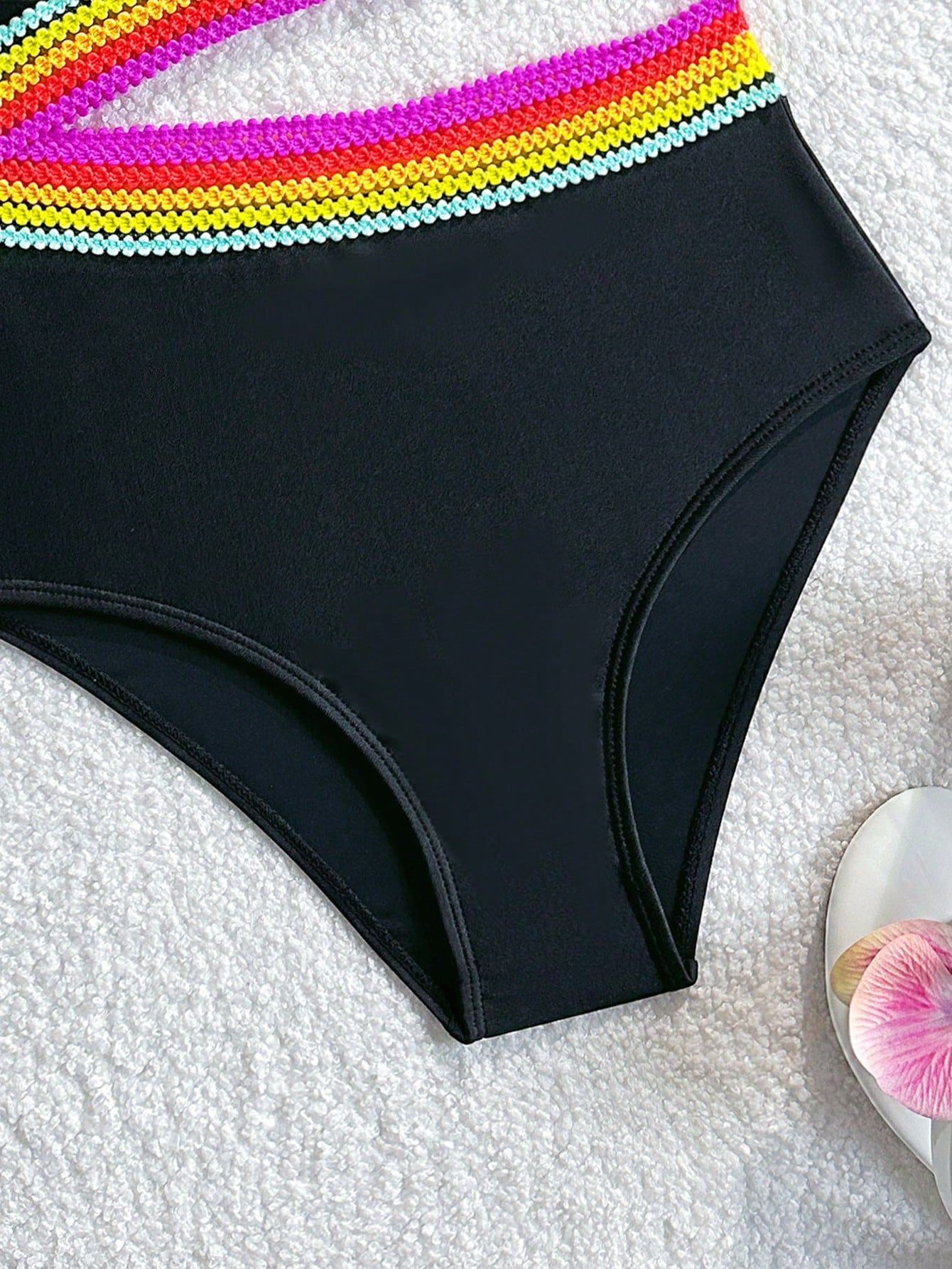 Black one-piece swimsuit for tween girls with cut out detail, spaghetti straps, high waist bottom, wireless bra, and fitted vacation swimwear style.