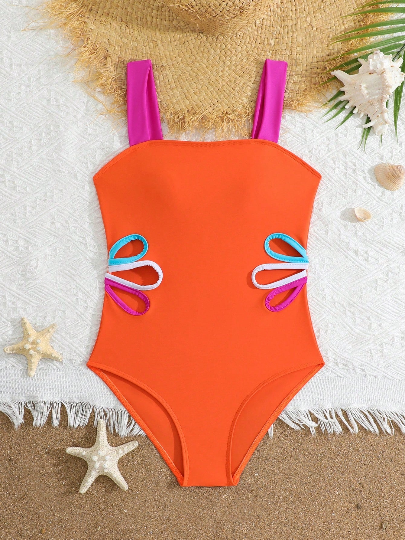 Tween girls one-piece swimsuit with a floral plant print, spaghetti straps, and a mid-waist fit in black.