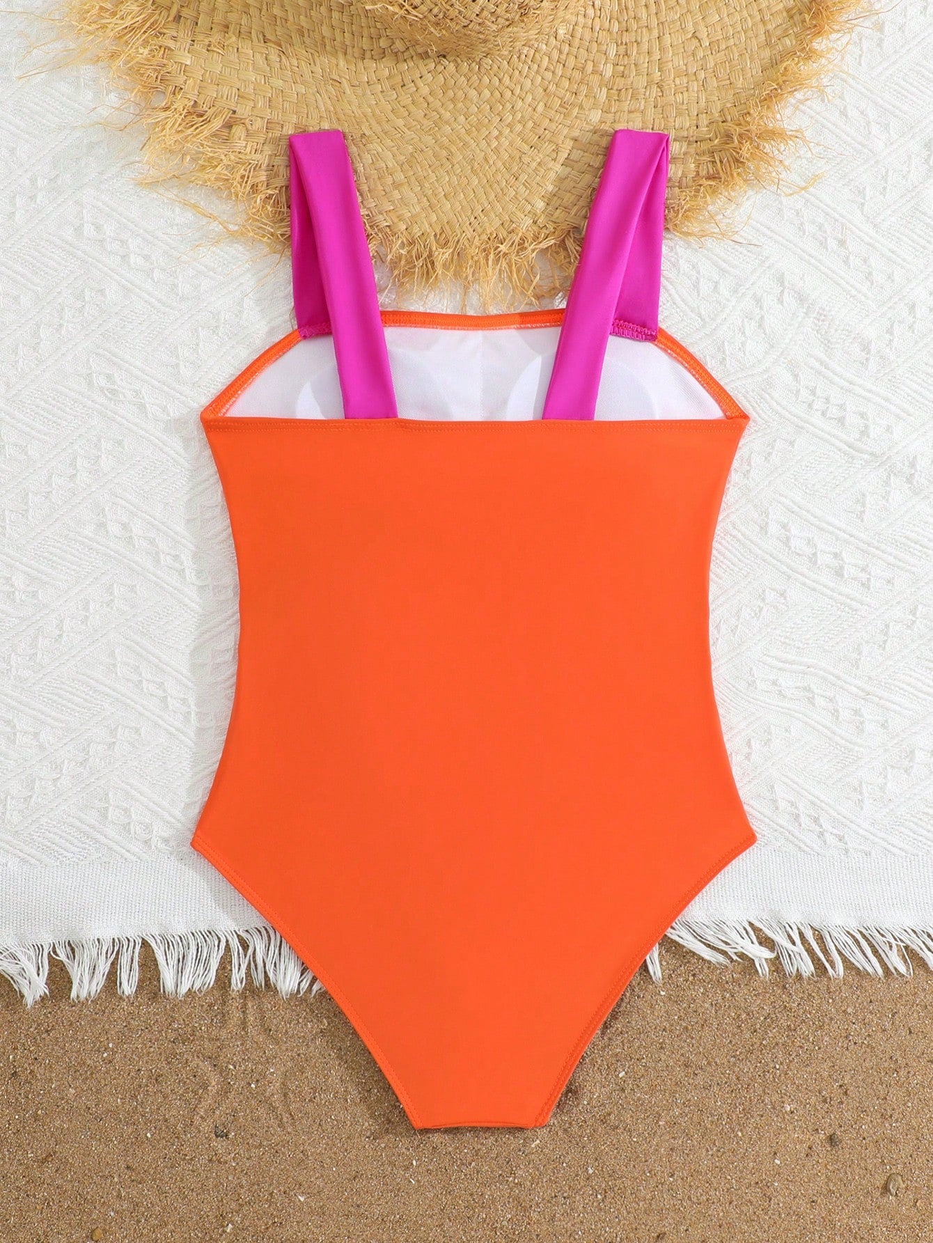 Tween girls one-piece swimsuit with a floral plant print, spaghetti straps, and a mid-waist fit in black.