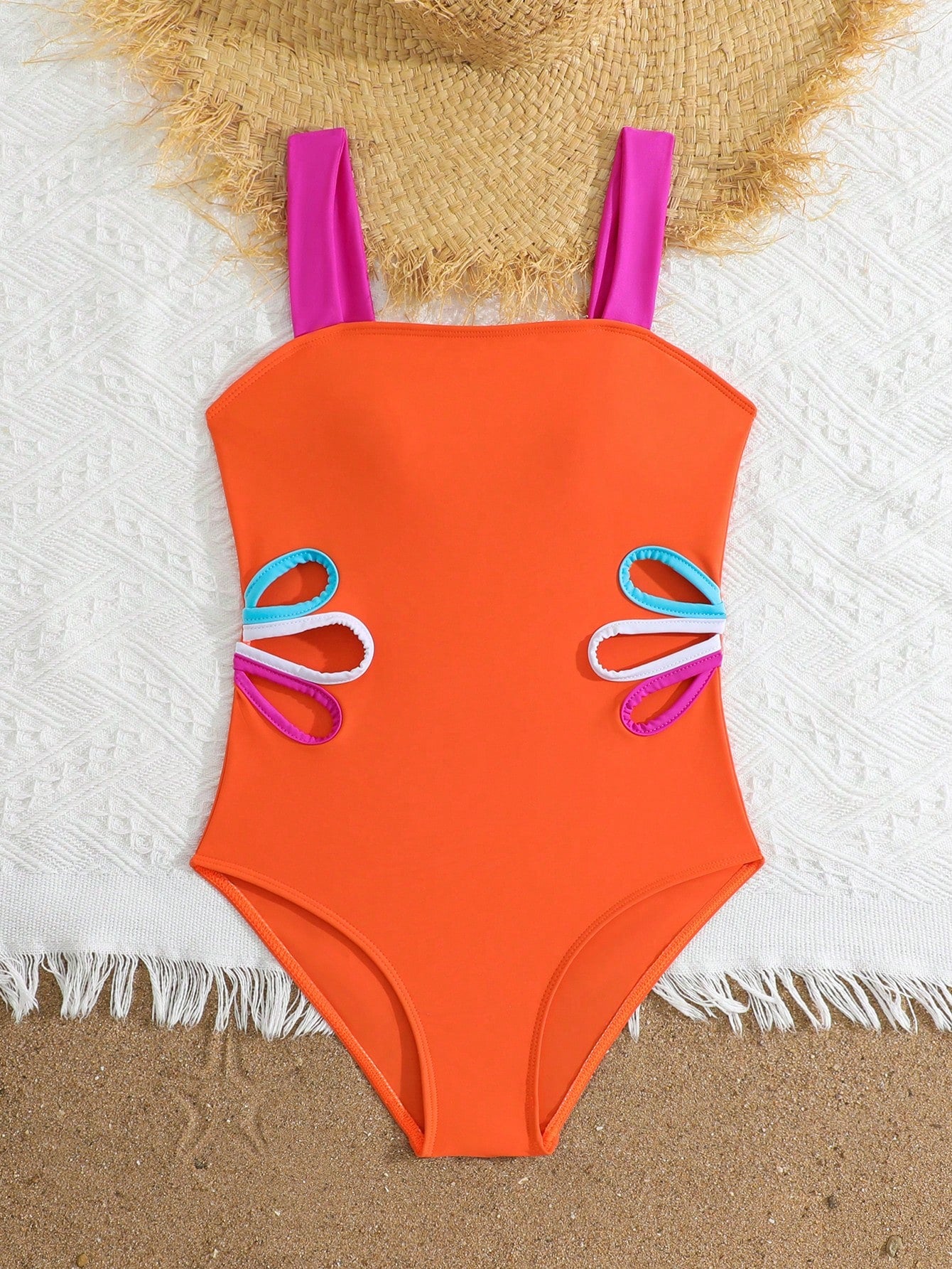 Tween girls one-piece swimsuit with a floral plant print, spaghetti straps, and a mid-waist fit in black.
