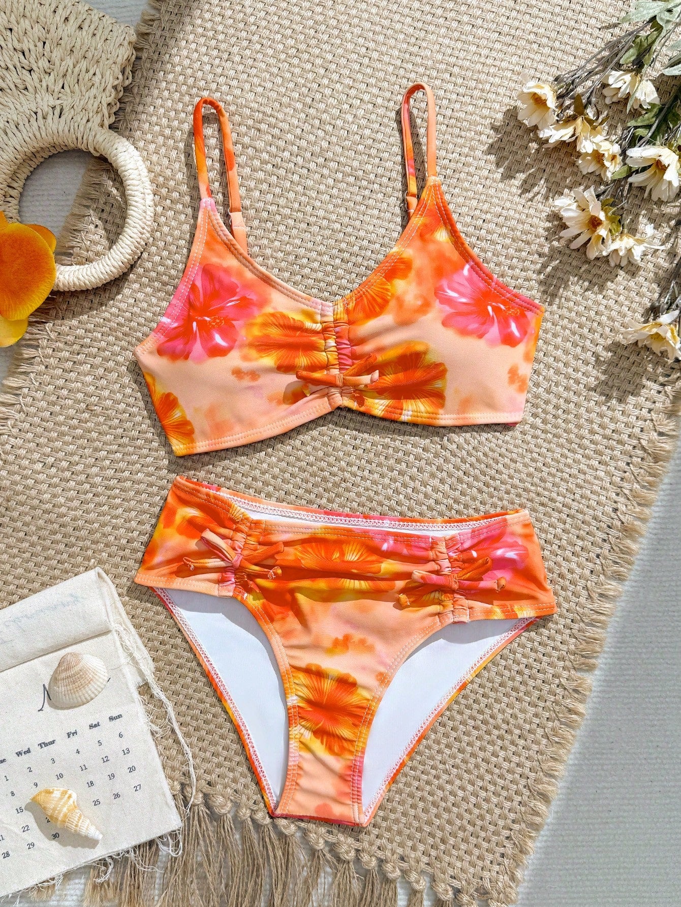 Tween girls 2-piece ditsy floral bikini set featuring a spaghetti strap top with center string detail and matching bottoms with side strings, designed for swimming, vacation, and summer wear.