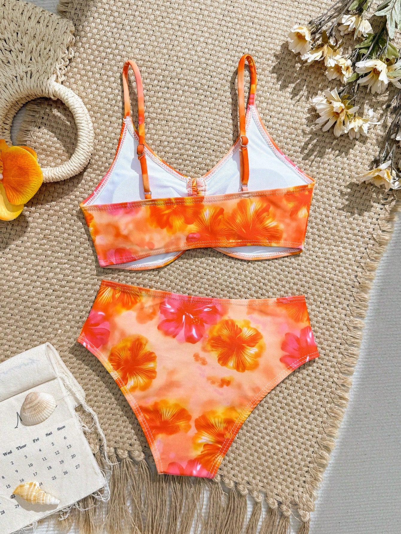 Tween girls 2-piece ditsy floral bikini set featuring a spaghetti strap top with center string detail and matching bottoms with side strings, designed for swimming, vacation, and summer wear.