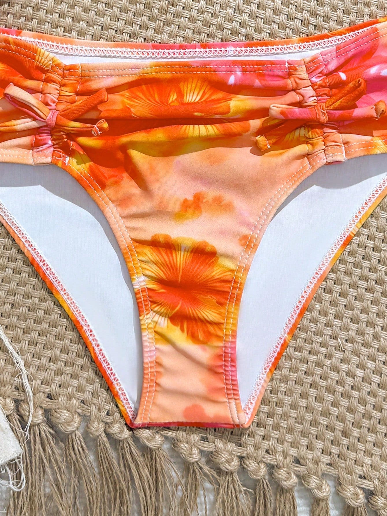 Tween girls 2-piece ditsy floral bikini set featuring a spaghetti strap top with center string detail and matching bottoms with side strings, designed for swimming, vacation, and summer wear.