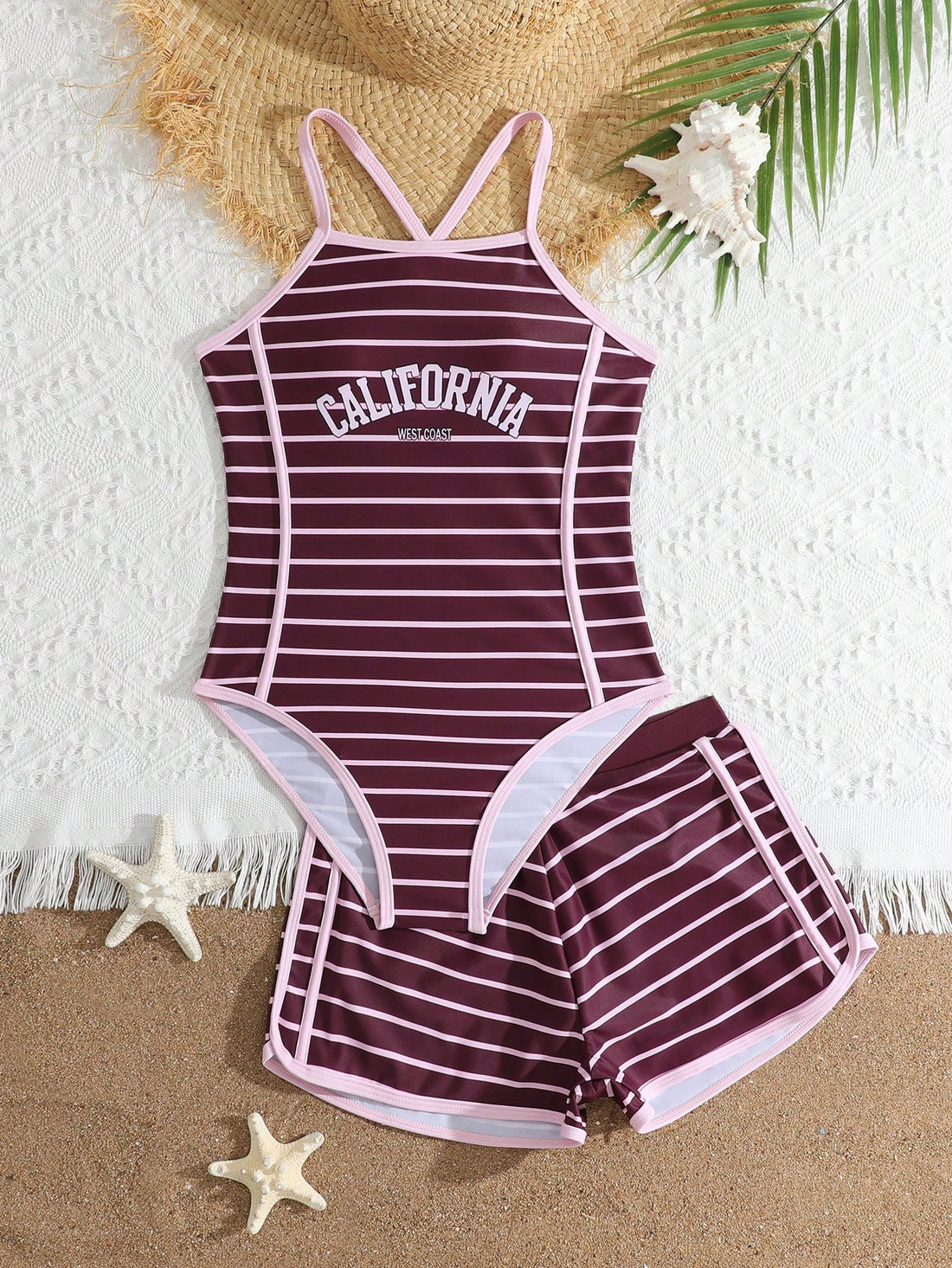 Girls' mauve purple one-piece swimsuit with swim shorts, spaghetti straps, contrast piping, letter pattern, and sleeveless vacation swimwear design.
