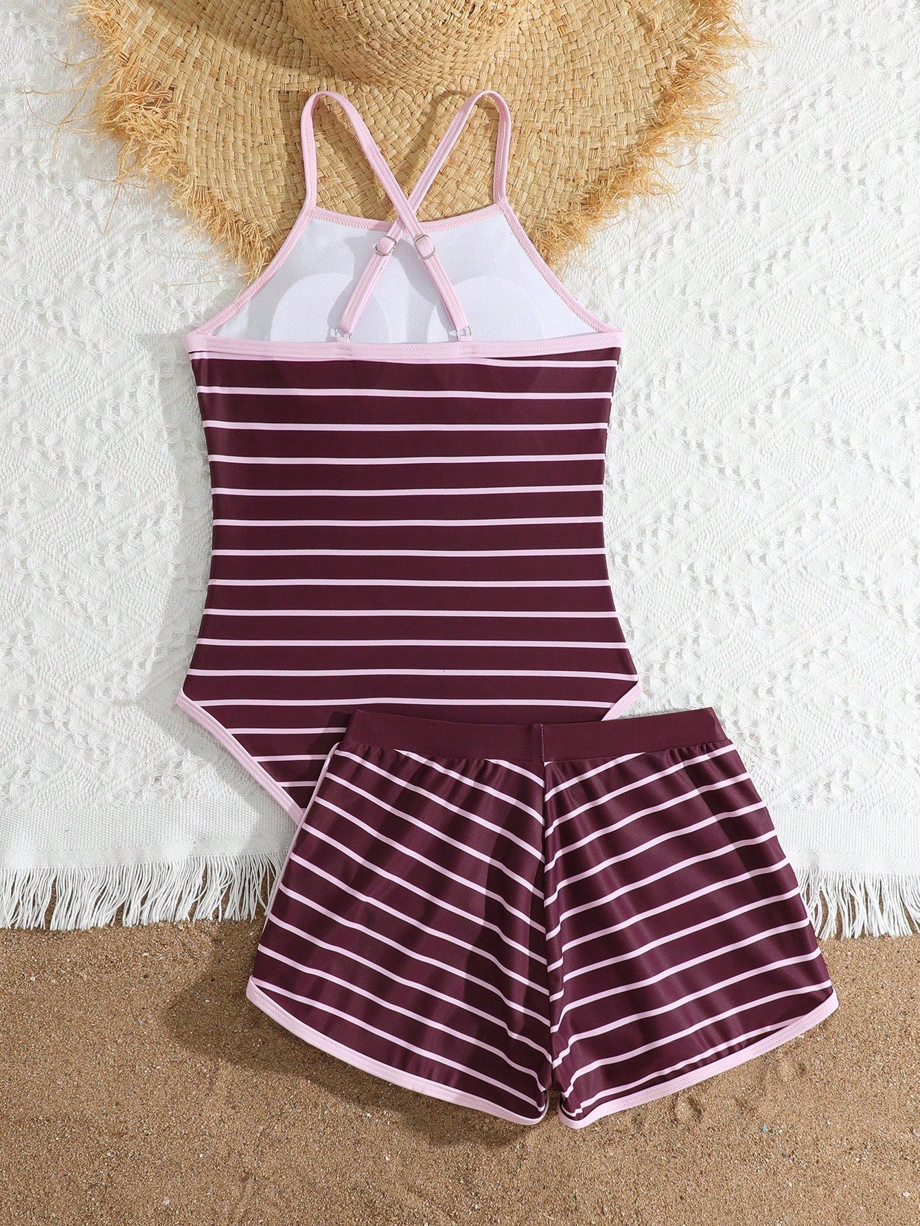 Girls' mauve purple one-piece swimsuit with swim shorts, spaghetti straps, contrast piping, letter pattern, and sleeveless vacation swimwear design.