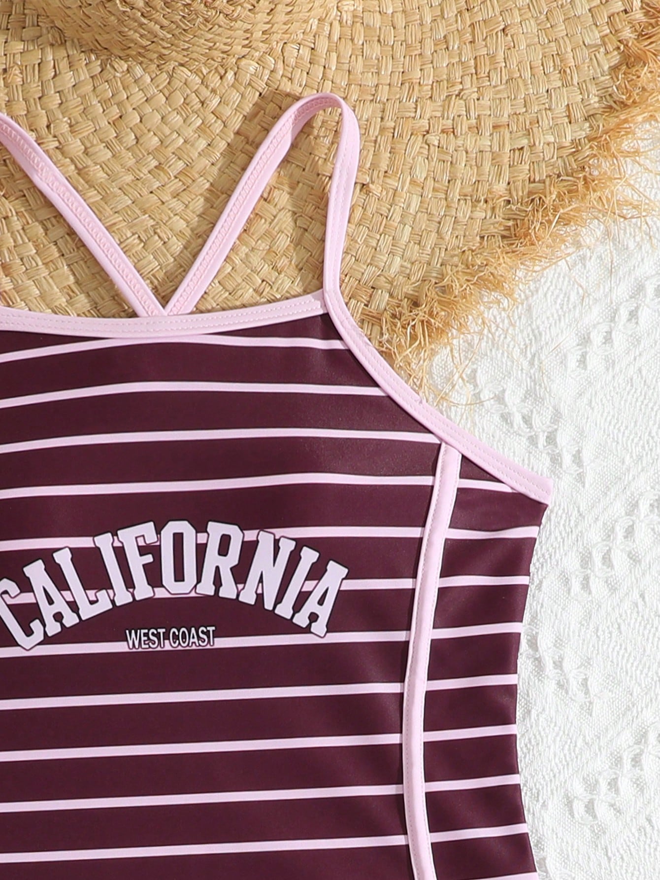 Girls' mauve purple one-piece swimsuit with swim shorts, spaghetti straps, contrast piping, letter pattern, and sleeveless vacation swimwear design.