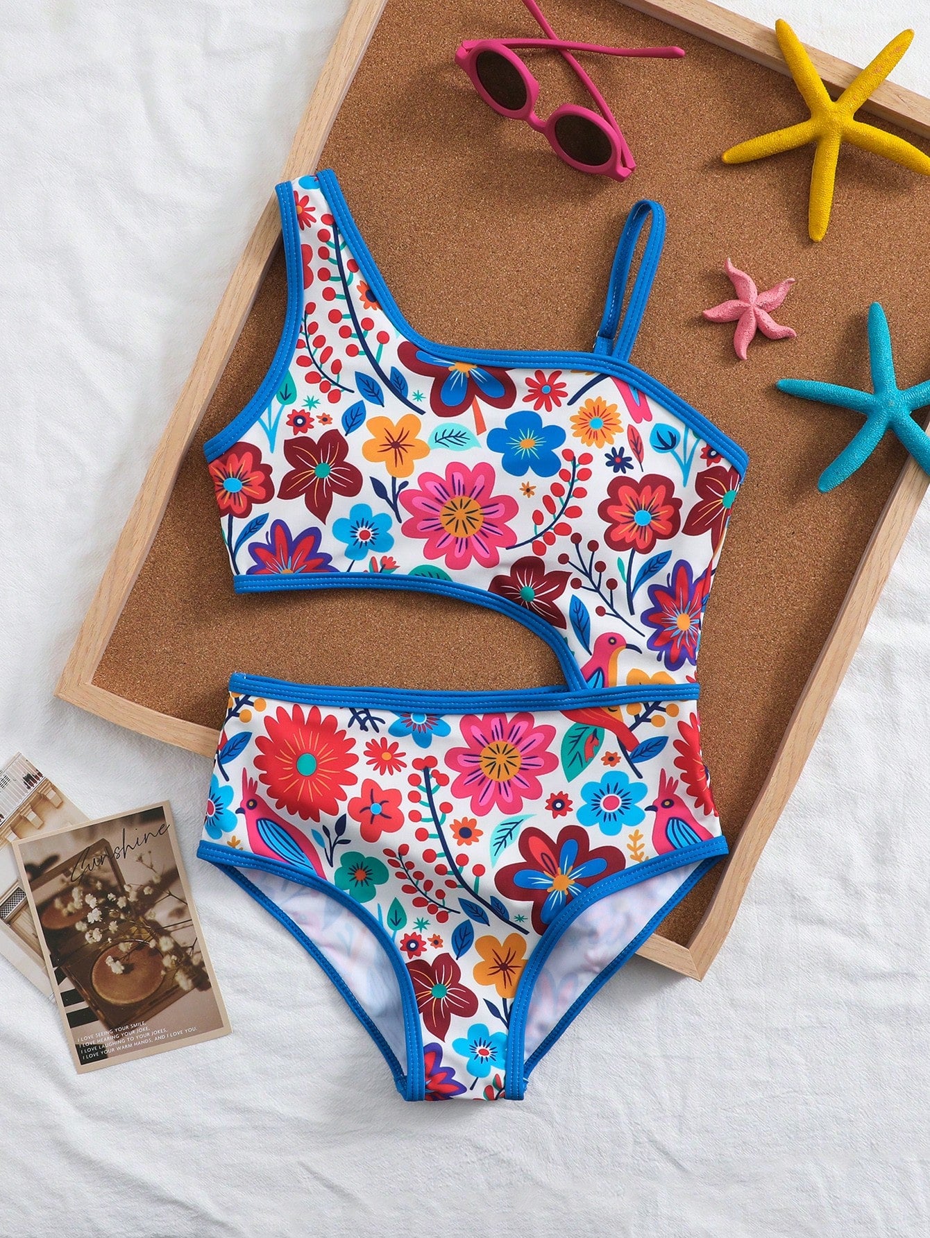 Tween girls one-piece swimsuit featuring an asymmetric neckline, pendant decor, plain design, wireless bra, high-cut bottom, and medium-stretch fabric.